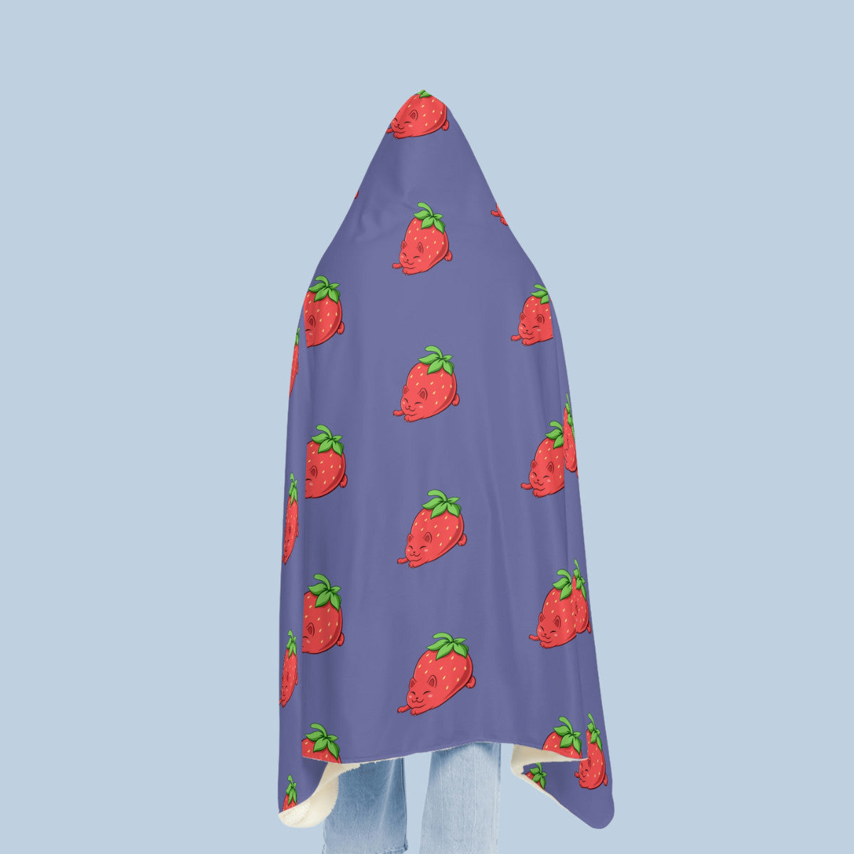 Happy woman wearing the purple Clawberry⢠hooded microfiber fleece blanket seen from behind. Clawberry⢠is a strawberry drawn as a cute cat.