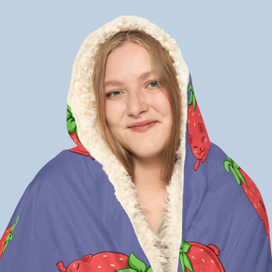 Happy woman wearing the purple Clawberry⢠hooded sherpa blanket face zoomed in. Clawberry⢠is a strawberry drawn as a cute cat.