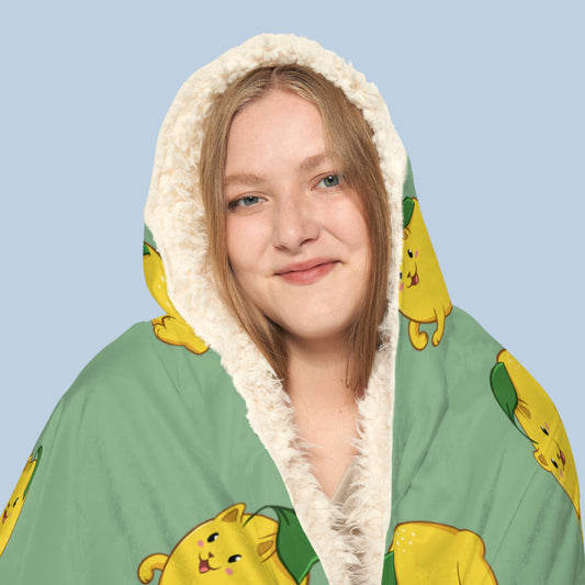 Happy woman wearing the light green Lemeow⢠hooded sherpa blanket face zoomed in. Lemeow⢠is a lemon drawn as a cute cat.