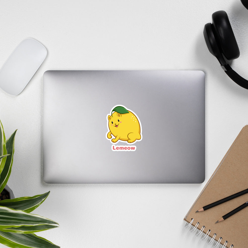 5.5 x 5.5 inch Sticker with Lemeow⢠print. The sticker is on a laptop. Lemeow⢠is a lemon drawn as a cute cat.