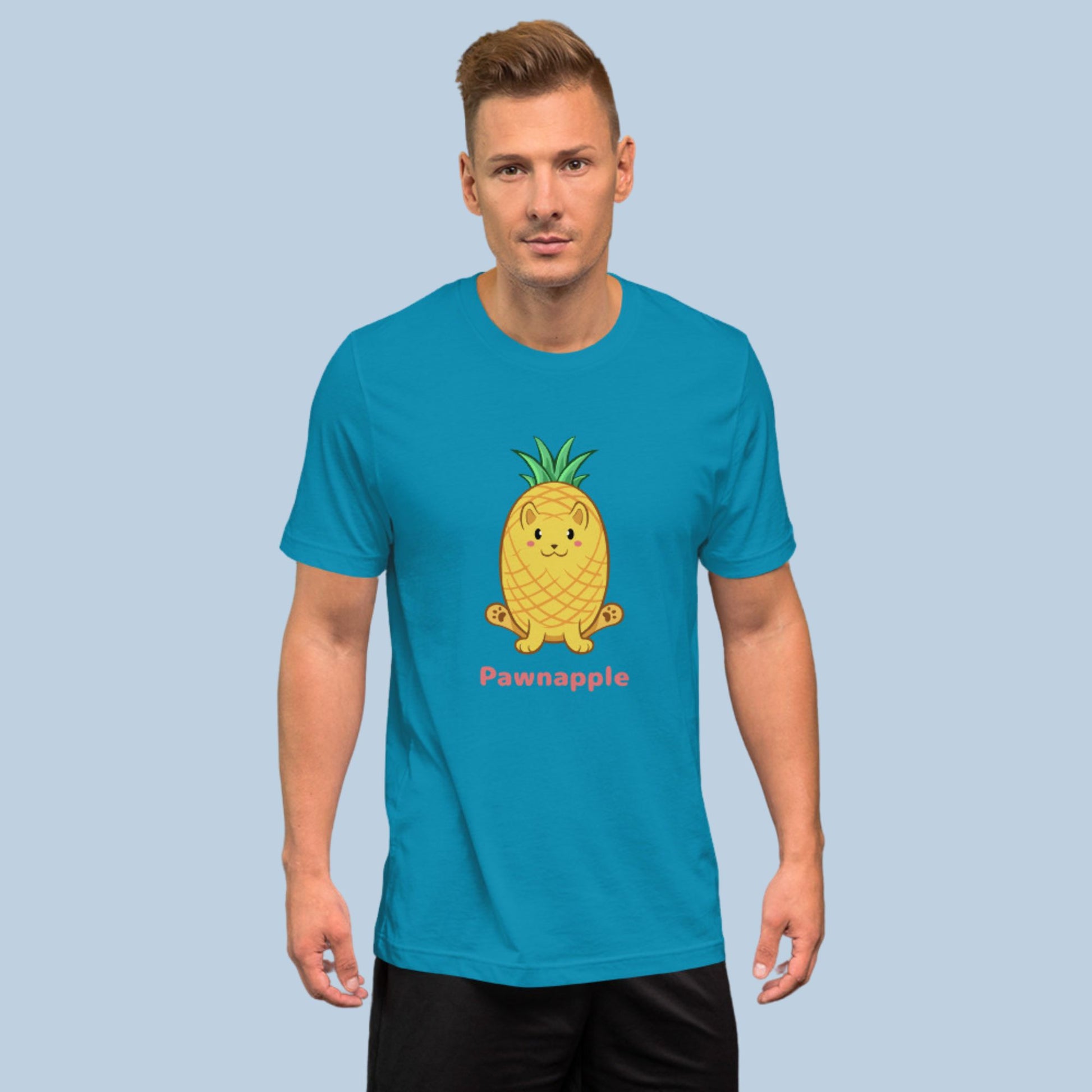 Man wearing an aqua blue T-Shirt with Pawnapple⢠print. Pawnapple⢠is a pineapple drawn as a cute cat.