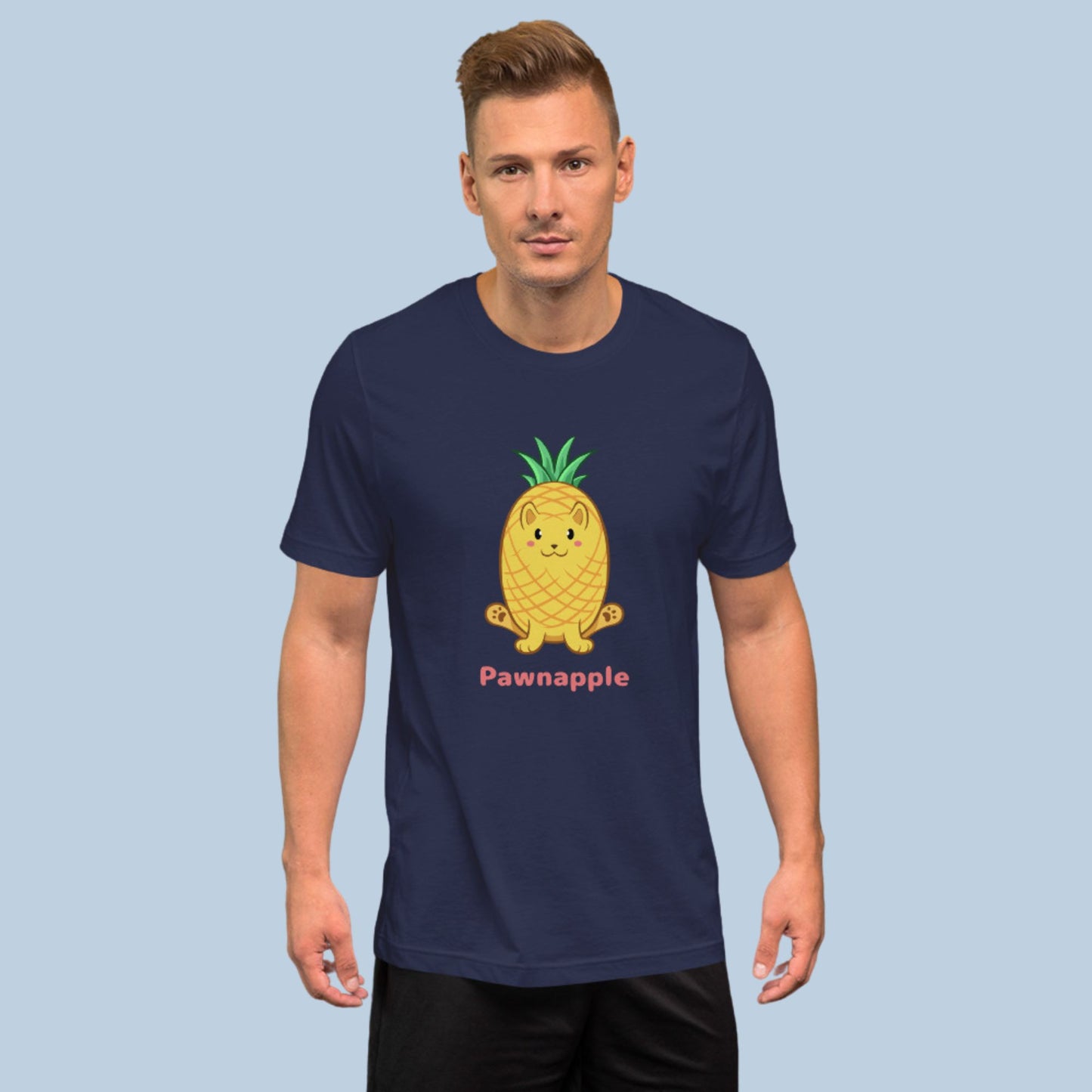 Man wearing a navy blue T-Shirt with Pawnapple⢠print. Pawnapple⢠is a pineapple drawn as a cute cat.