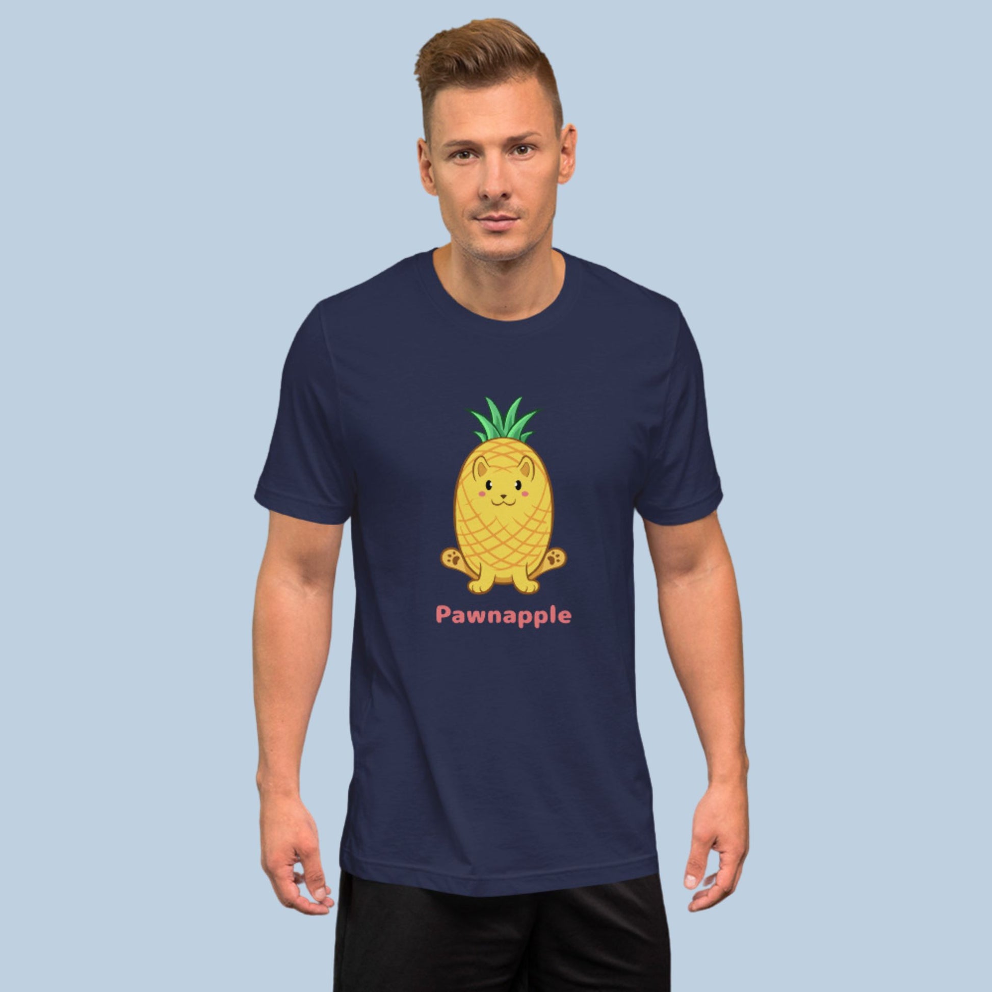 Man wearing a navy blue T-Shirt with Pawnapple⢠print. Pawnapple⢠is a pineapple drawn as a cute cat.