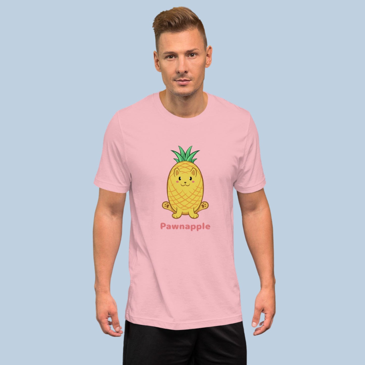 Man wearing a pink T-Shirt with Pawnapple⢠print. Pawnapple⢠is a pineapple drawn as a cute cat.