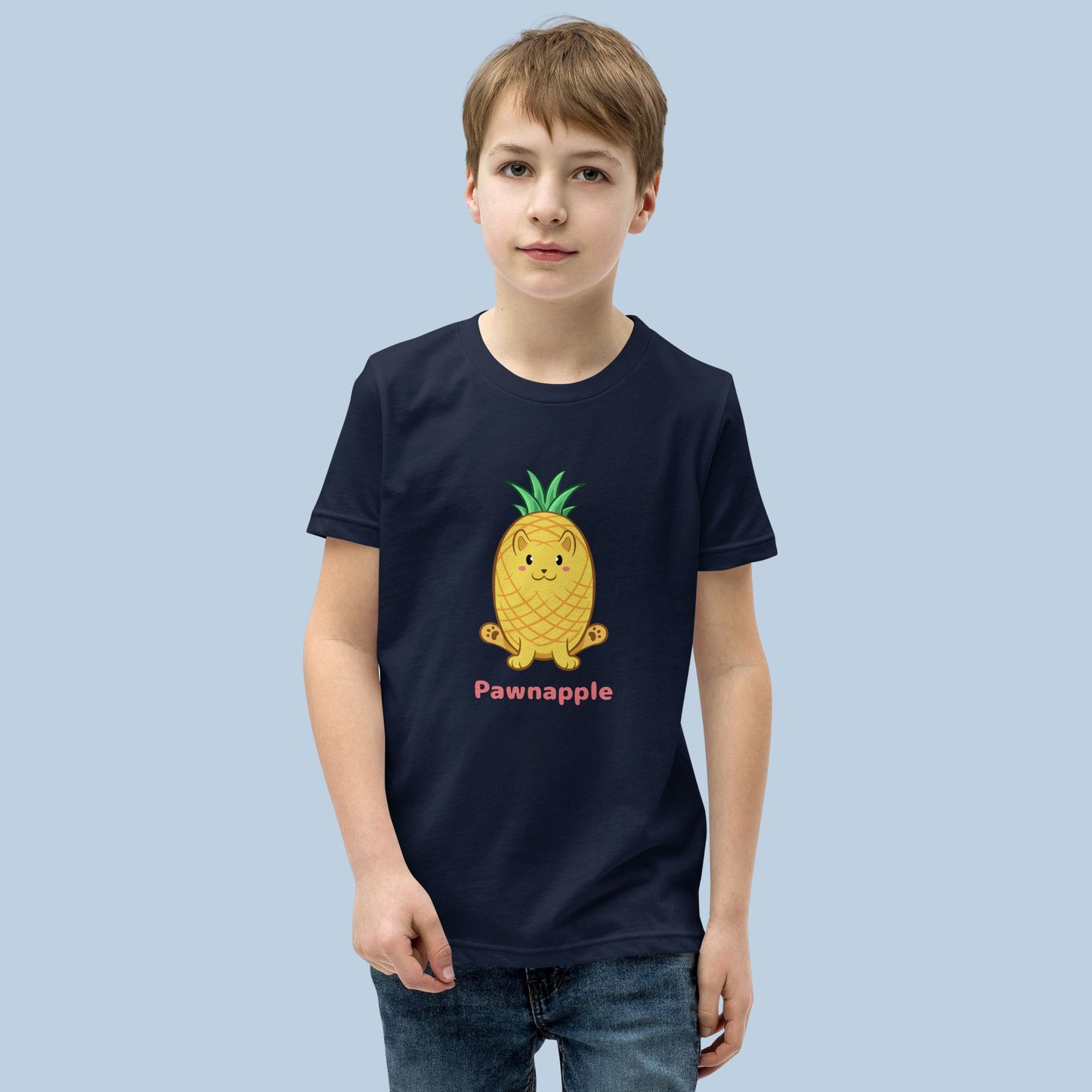 Boy wearing a navy blue T-Shirt with Pawnapple⢠print. Pawnapple⢠is a pineapple drawn as a cute cat.