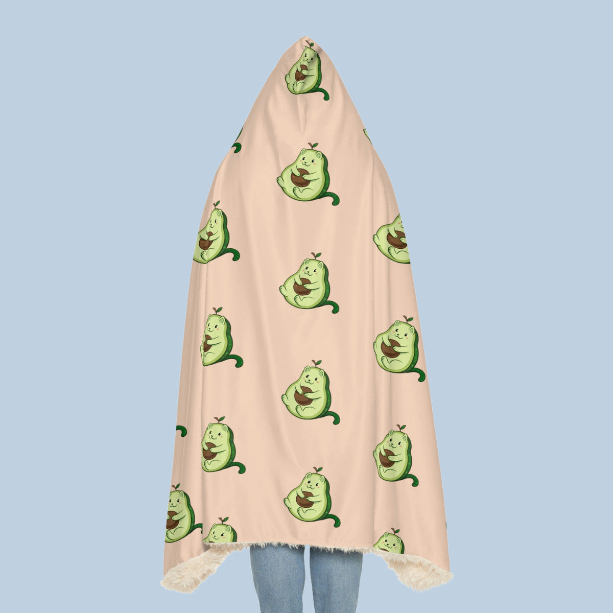 Happy woman wearing the beige Pawocado⢠hooded sherpa blanket seen from behind. Pawocado⢠is an avocado drawn as a cute cat.