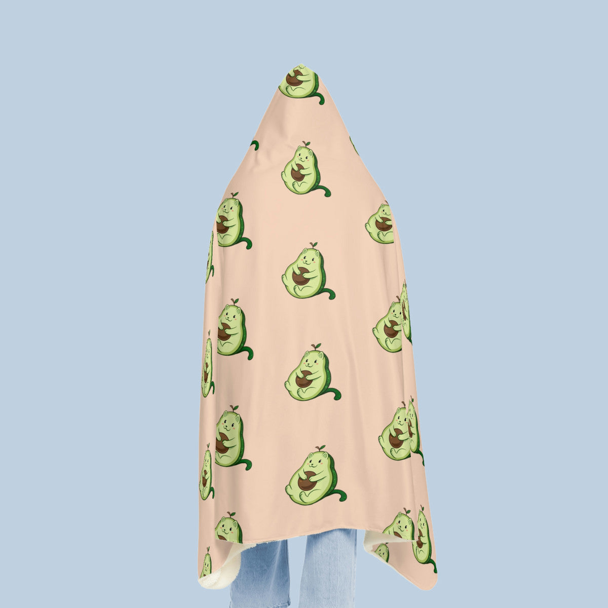 Happy woman wearing the beige Pawocado⢠hooded microfiber fleece blanket seen from behind. Pawocado⢠is an avocado drawn as a cute cat.