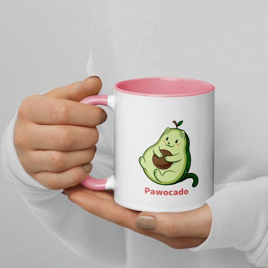 Hands holding a white and pink Coffee Mug with Pawocado⢠print. Pawocado⢠is an avocado drawn as a cute cat.