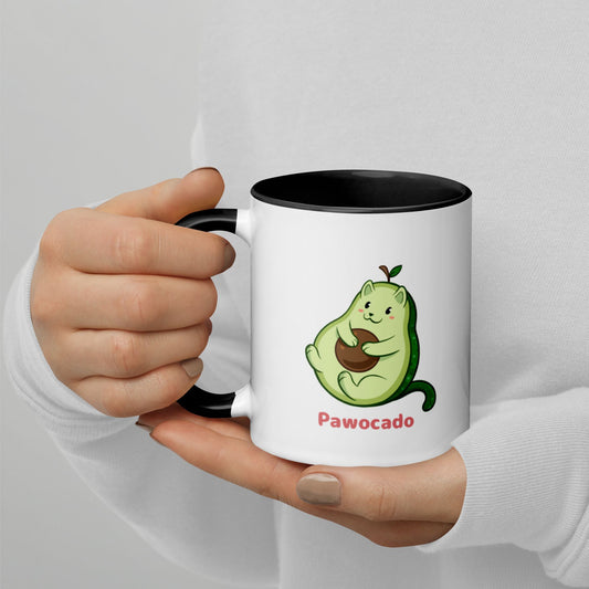Hands holding a white and black Coffee Mug with Pawocado⢠print. Pawocado⢠is an avocado drawn as a cute cat.