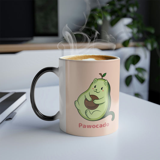 Beige Magic Mug with Pawocado⢠print standing on an office desk. Pawocado⢠is an avocado drawn as a cute cat.