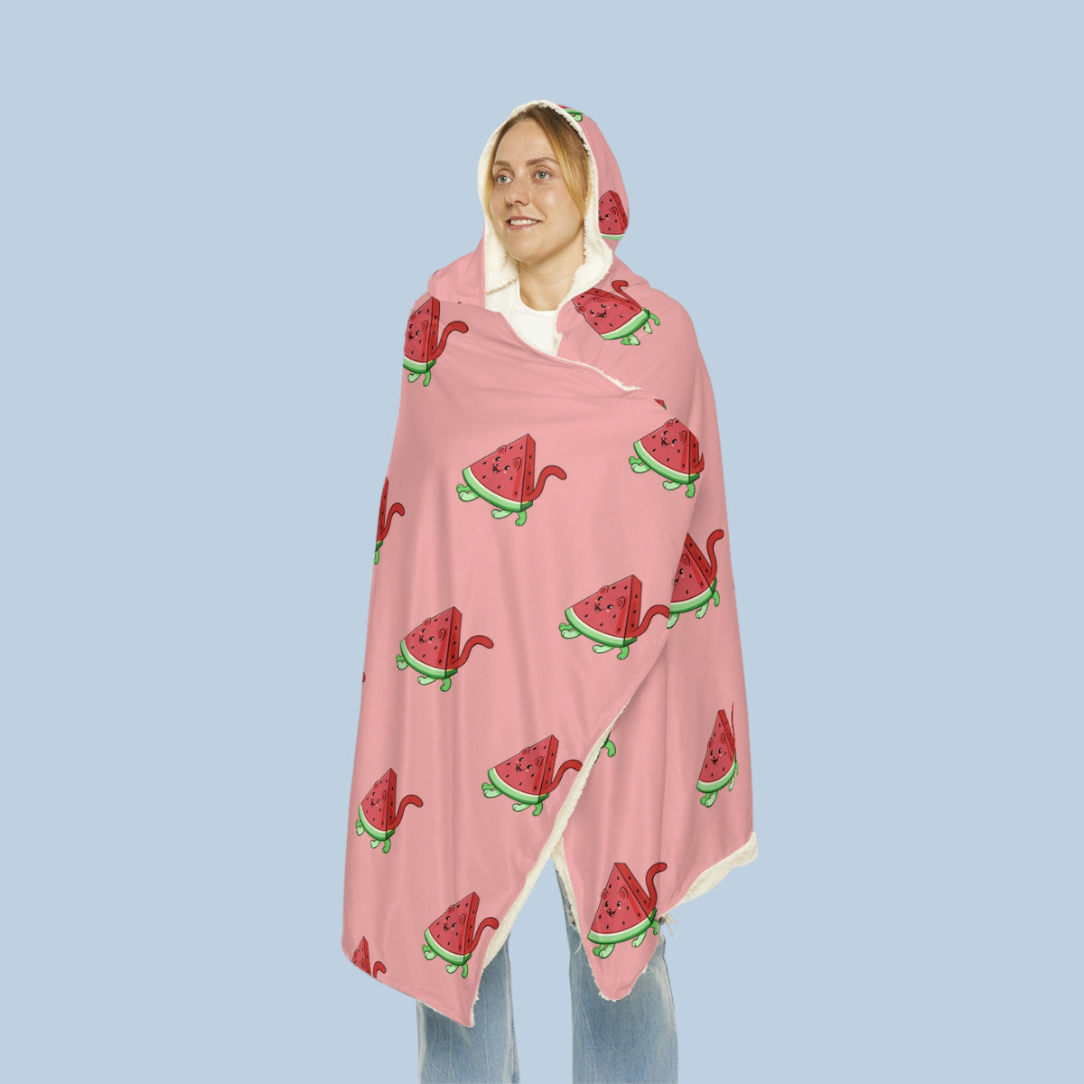 Happy woman wearing the pink Watermewlon⢠hooded microfiber fleece blanket seen from front. Watermewlon⢠is a watermelon drawn as a cute cat.