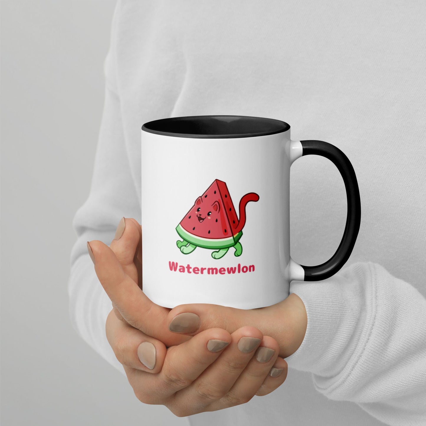 Hands holding a white and black Coffee Mug with Watermewlon⢠print. Watermewlon⢠is a watermelon drawn as a cute cat.