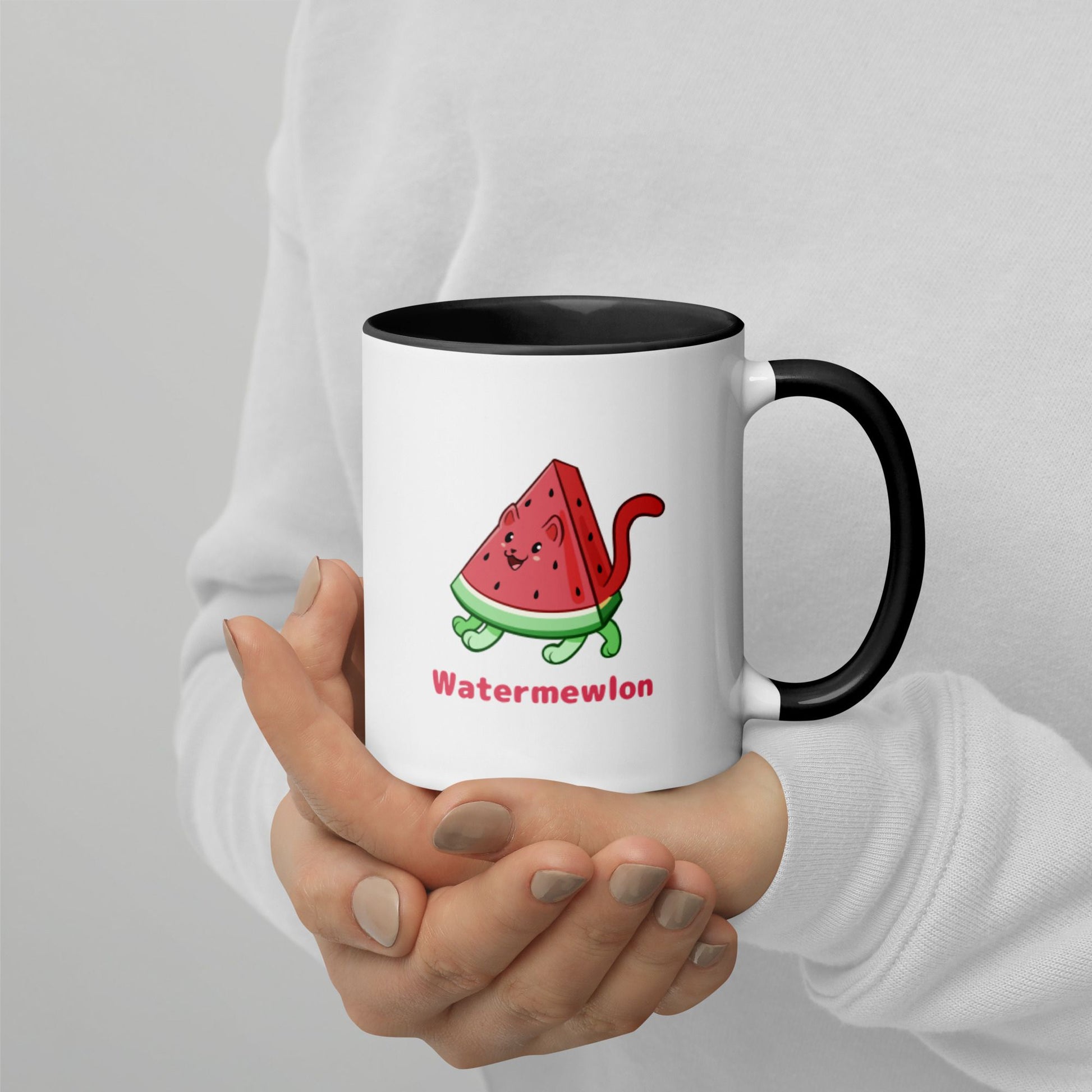 Hands holding a white and black Coffee Mug with Watermewlon⢠print. Watermewlon⢠is a watermelon drawn as a cute cat.
