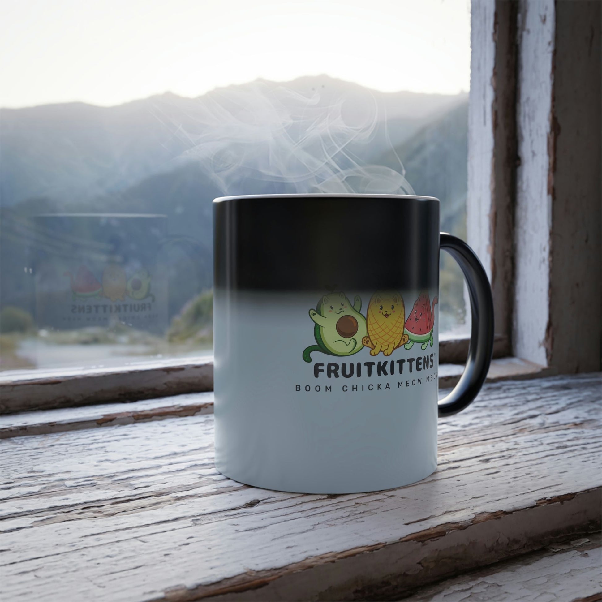 Light Blue Magic Mug with Fruitkittens⢠logo standing in a window turning from black into the print. Fruitkittens⢠are fruits drawn as cute cats. The logo features Pawocadoâ˘, Pawnapple⢠and Watermewlonâ˘