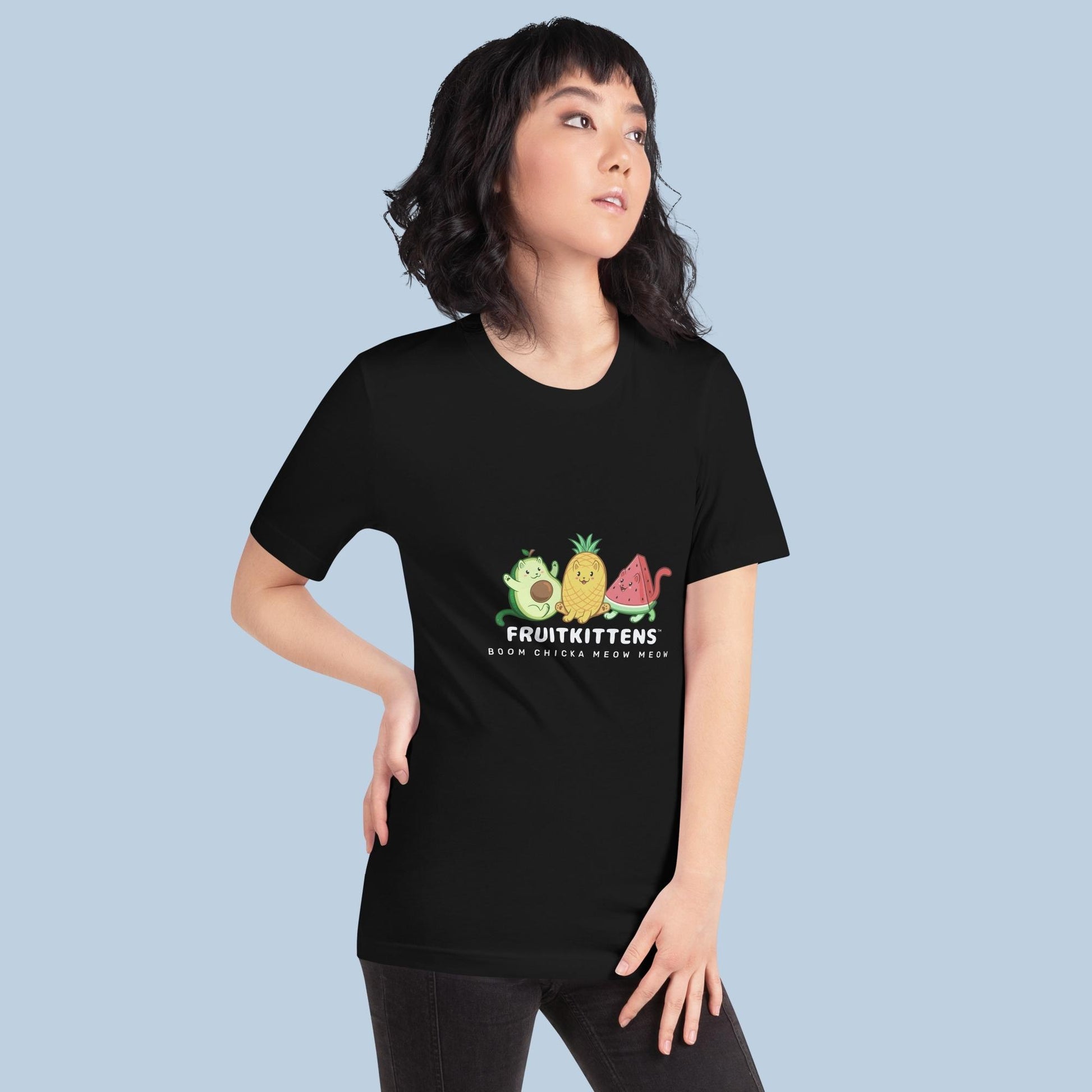Woman wearing a black T-Shirt with Fruitkittens⢠logo. Fruitkittens⢠are fruits drawn as cute cats. The logo features Pawocadoâ˘, Pawnapple⢠and Watermewlonâ˘.