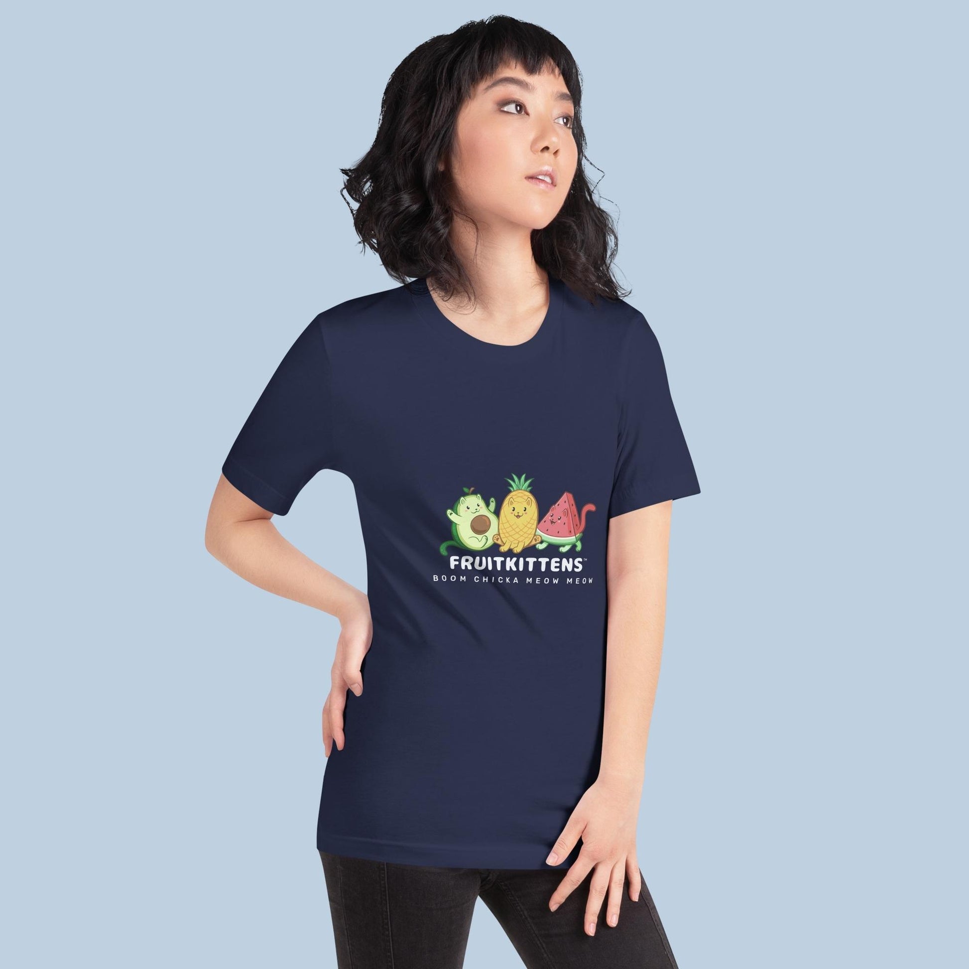 Woman wearing a navy blue T-Shirt with Fruitkittens⢠logo. Fruitkittens⢠are fruits drawn as cute cats. The logo features Pawocadoâ˘, Pawnapple⢠and Watermewlonâ˘.