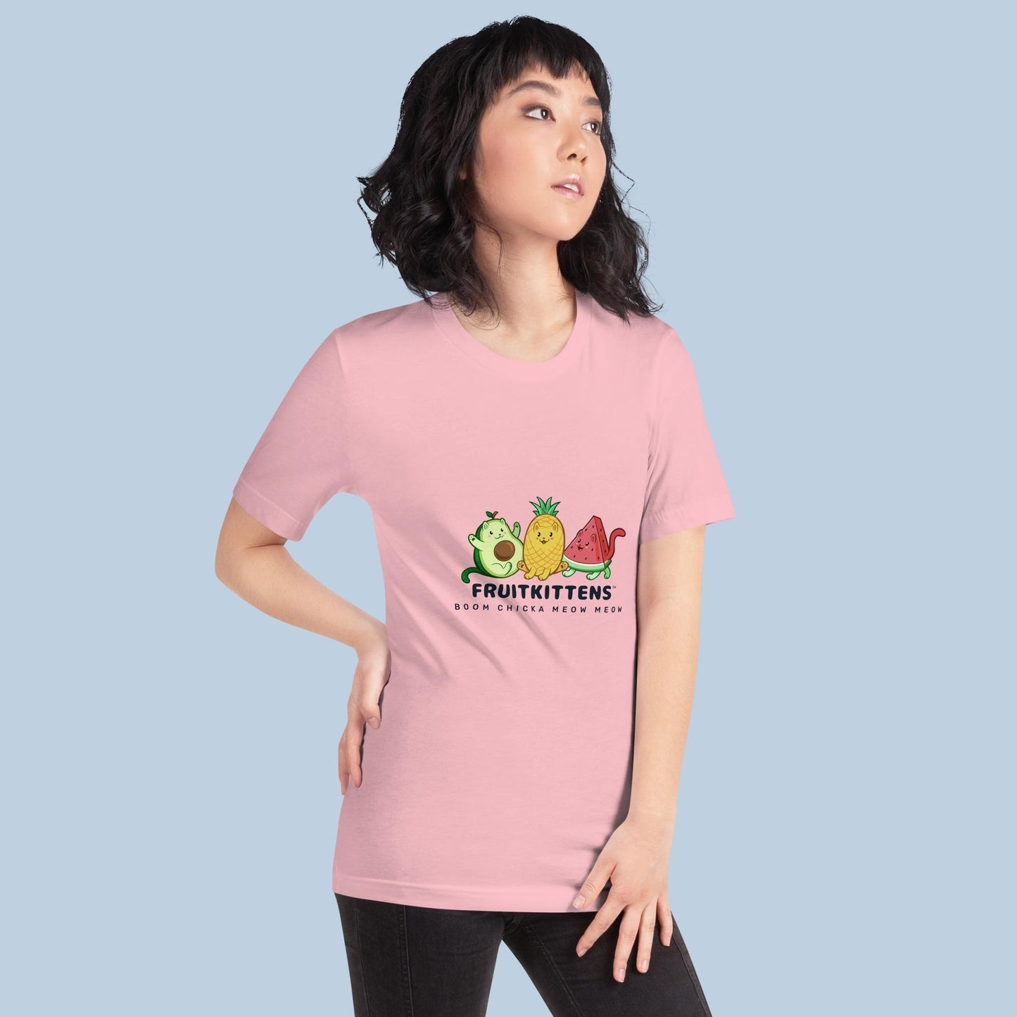Woman wearing a pink T-Shirt with Fruitkittens⢠logo. Fruitkittens⢠are fruits drawn as cute cats. The logo features Pawocadoâ˘, Pawnapple⢠and Watermewlonâ˘.