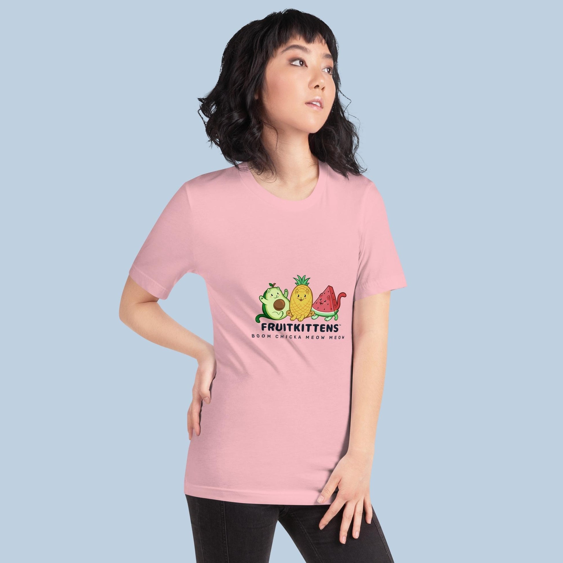 Woman wearing a pink T-Shirt with Fruitkittens⢠logo. Fruitkittens⢠are fruits drawn as cute cats. The logo features Pawocadoâ˘, Pawnapple⢠and Watermewlonâ˘.