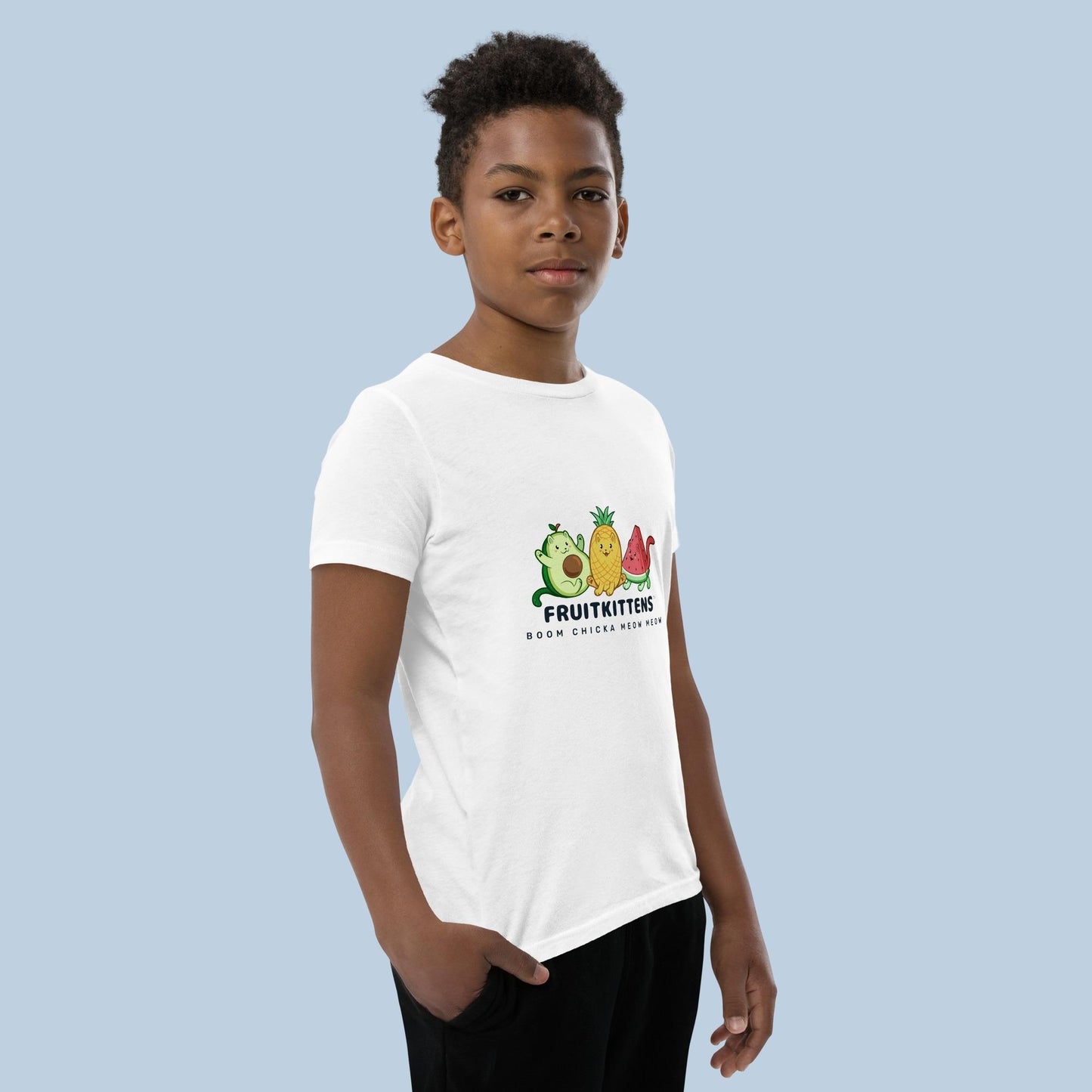 Boy wearing a white T-Shirt with Fruitkittens⢠logo. Fruitkittens⢠are fruits drawn as cute cats. The logo features Pawocadoâ˘, Pawnapple⢠and Watermewlonâ˘.