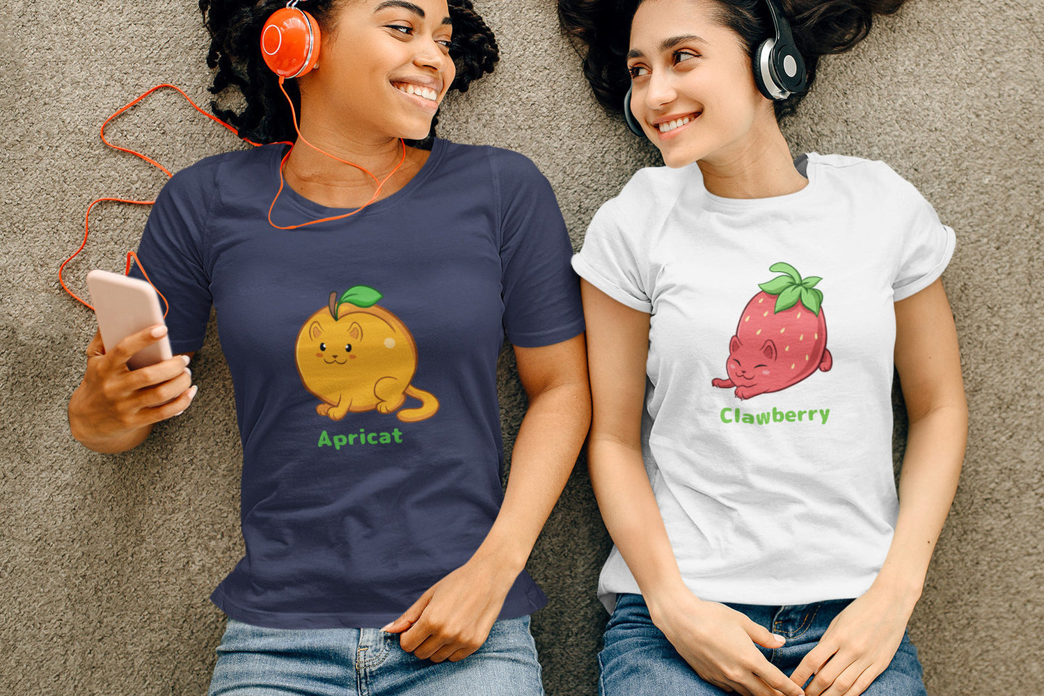 Two friends wearing Fruitkitten T-shirts. The girl on the left is wearing a navy Apricat T-Shirt, the girl on the right is wearing a white Clawberry T-Shirt.