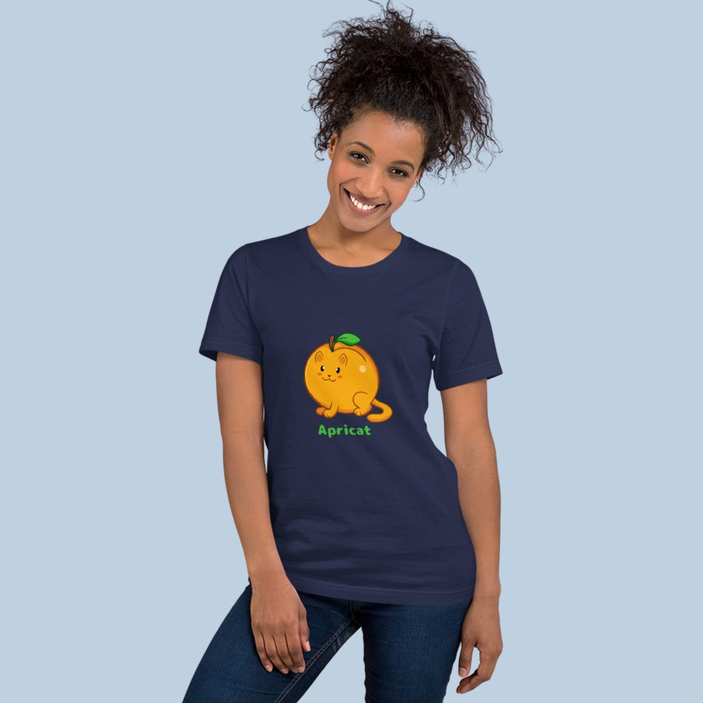 Woman wearing a navy blue T-Shirt with Apricat™ print. Apricat™ is an apricot drawn as a cute cat.