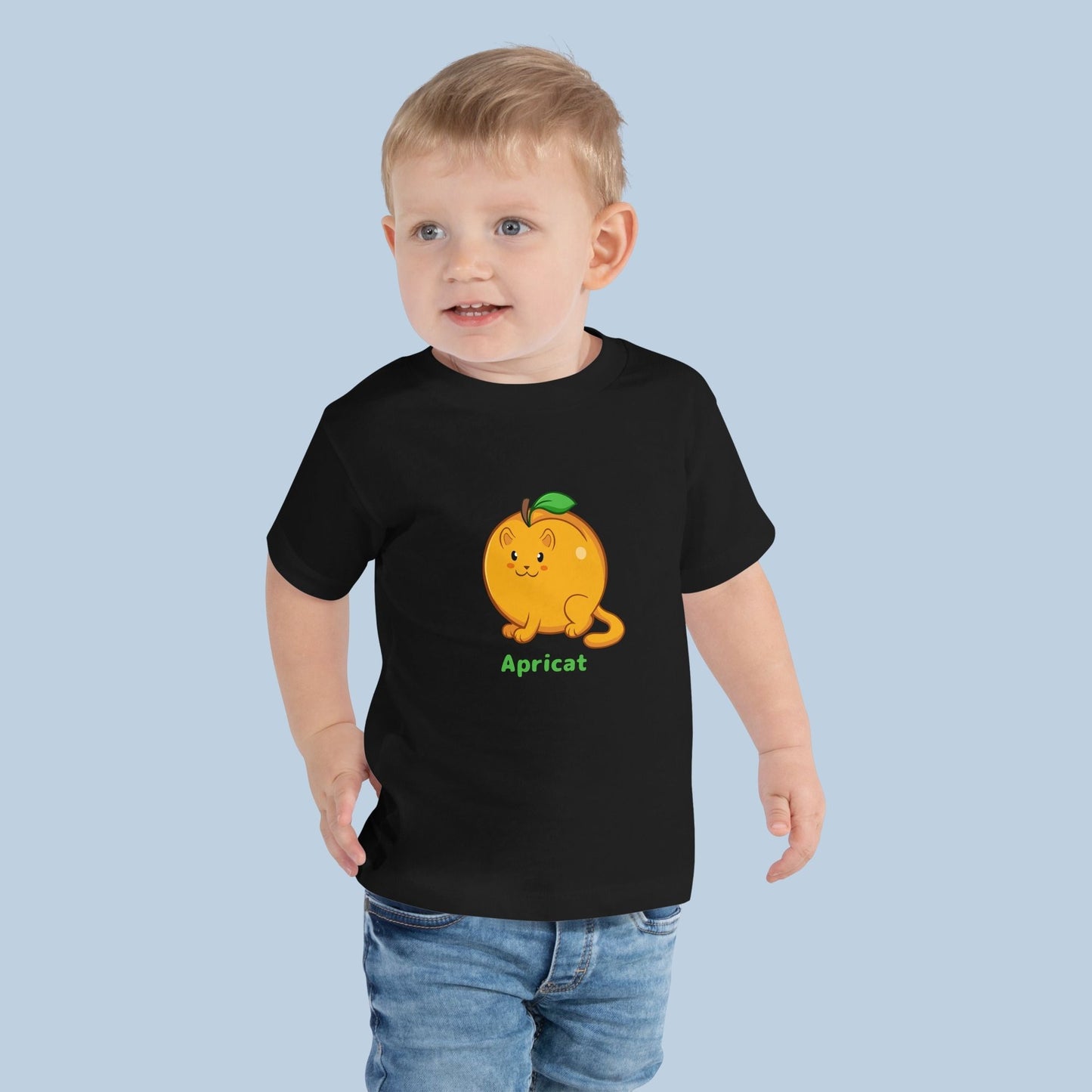 Toddler wearing a black Toddler T-Shirt with Apricat™ print. Apricat™ is an apricot drawn as a cute cat.