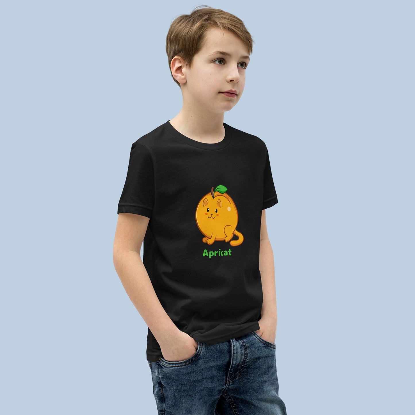 Boy wearing a black T-Shirt with Apricat™ print. Apricat™ is an apricot drawn as a cute cat.