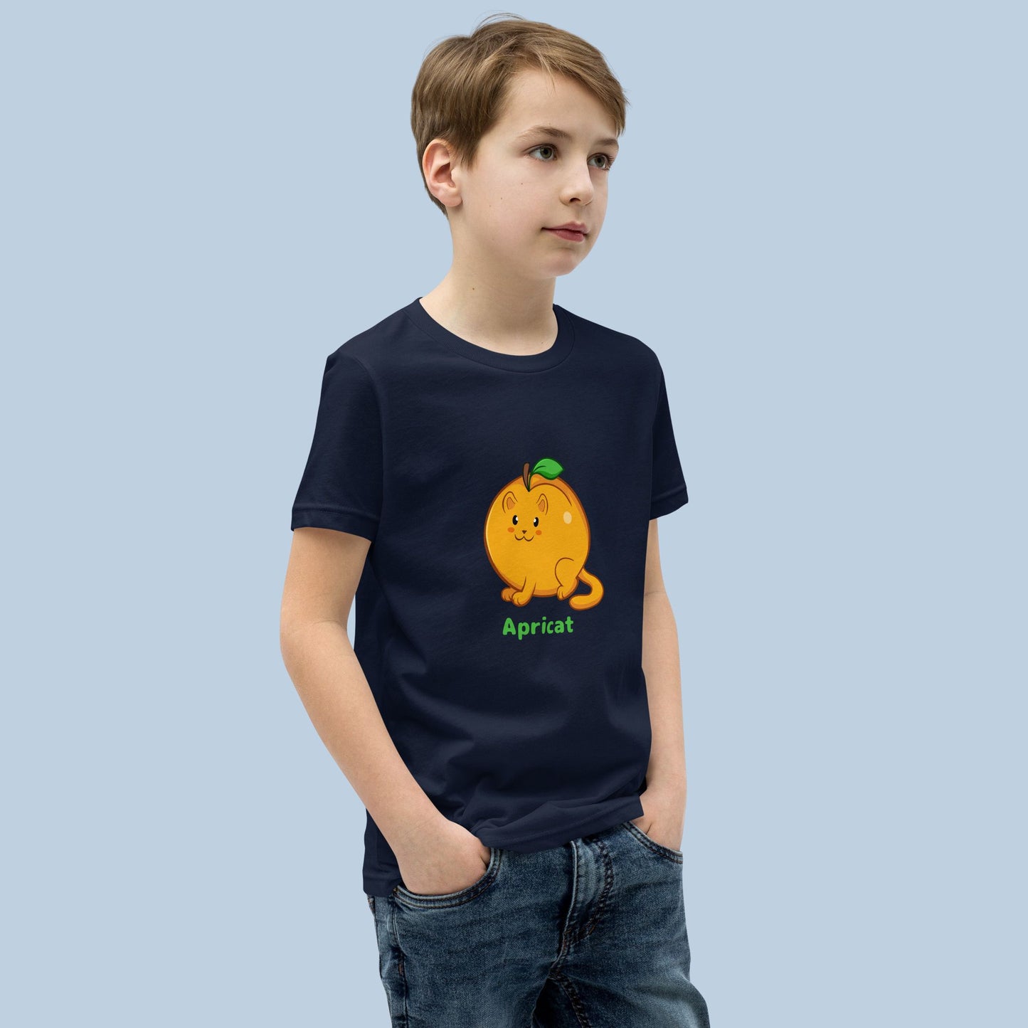 Boy wearing a navy blue T-Shirt with Apricat™ print. Apricat™ is an apricot drawn as a cute cat.