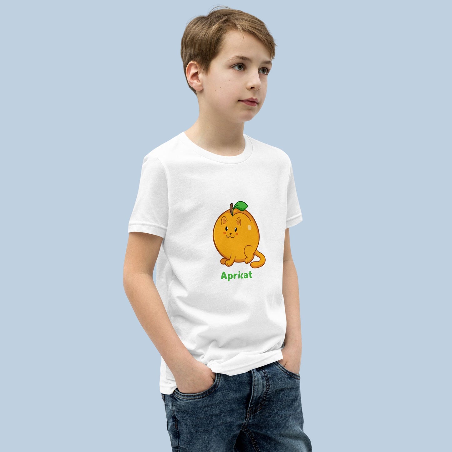 Boy wearing a white T-Shirt with Apricat™ print. Apricat™ is an apricot drawn as a cute cat.