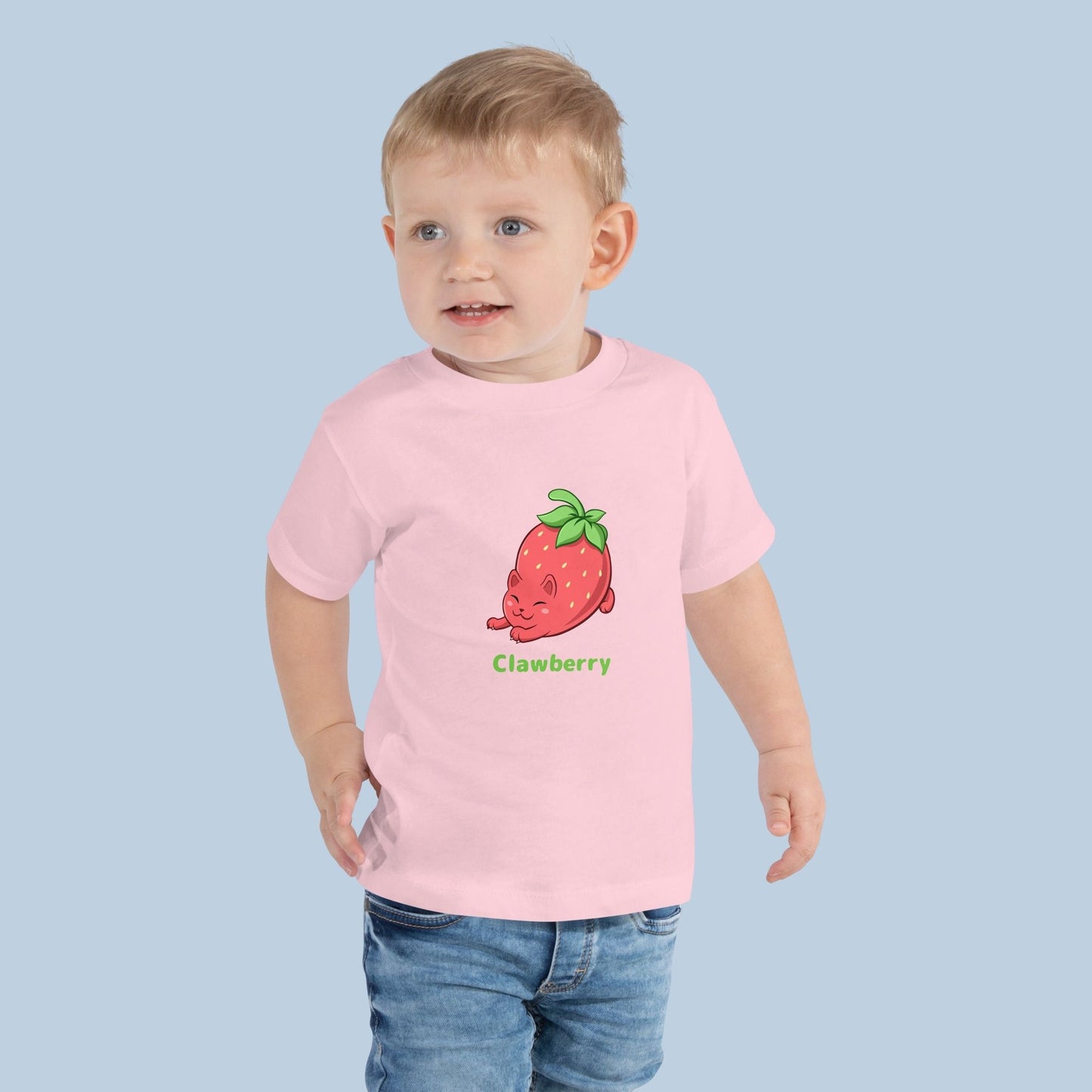 Toddler wearing a pink Toddler T-Shirt with Clawberry™ print. Clawberry™ is a strawberry drawn as a cute cat.