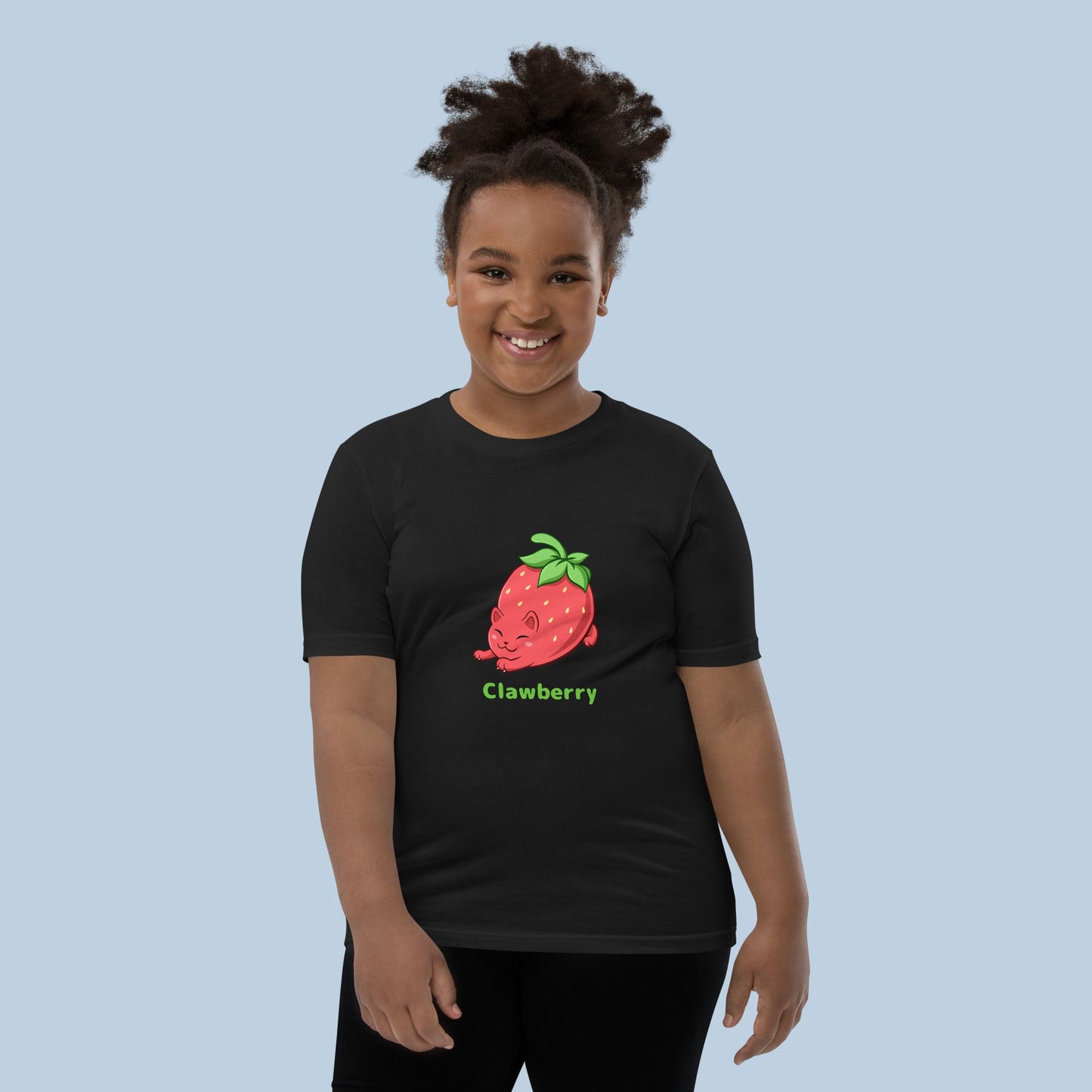 Girl wearing a black T-Shirt with Clawberry™ print. Clawberry™ is a strawberry drawn as a cute cat.