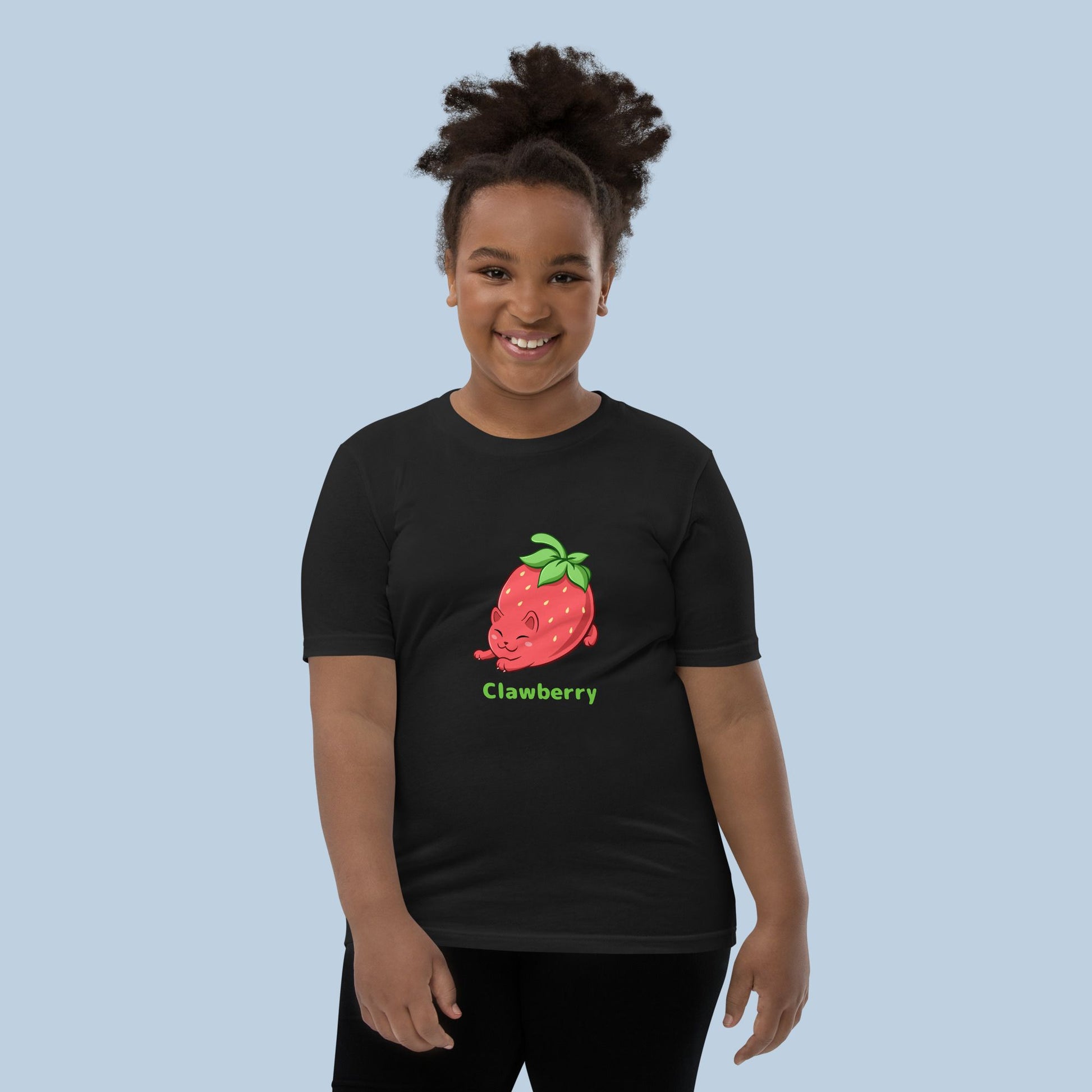 Girl wearing a black T-Shirt with Clawberry™ print. Clawberry™ is a strawberry drawn as a cute cat.