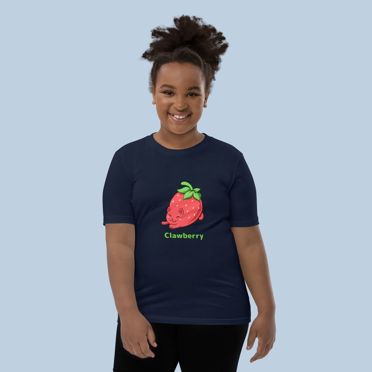 Girl wearing a navy blue T-Shirt with Clawberry™ print. Clawberry™ is a strawberry drawn as a cute cat.