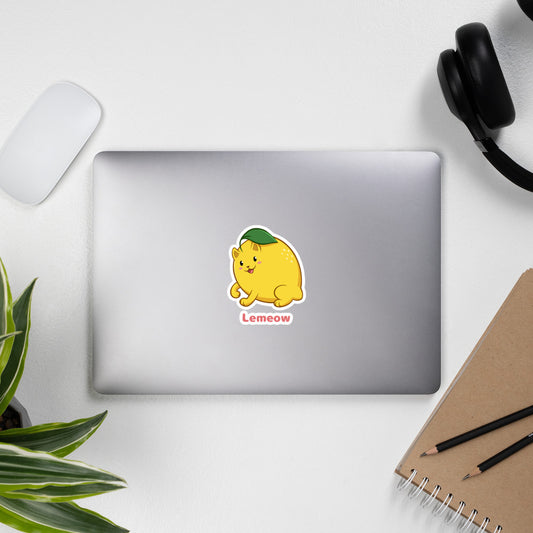 5.5 x 5.5 inch Sticker with Lemeow™ print. The sticker is on a laptop. Lemeow™ is a lemon drawn as a cute cat.