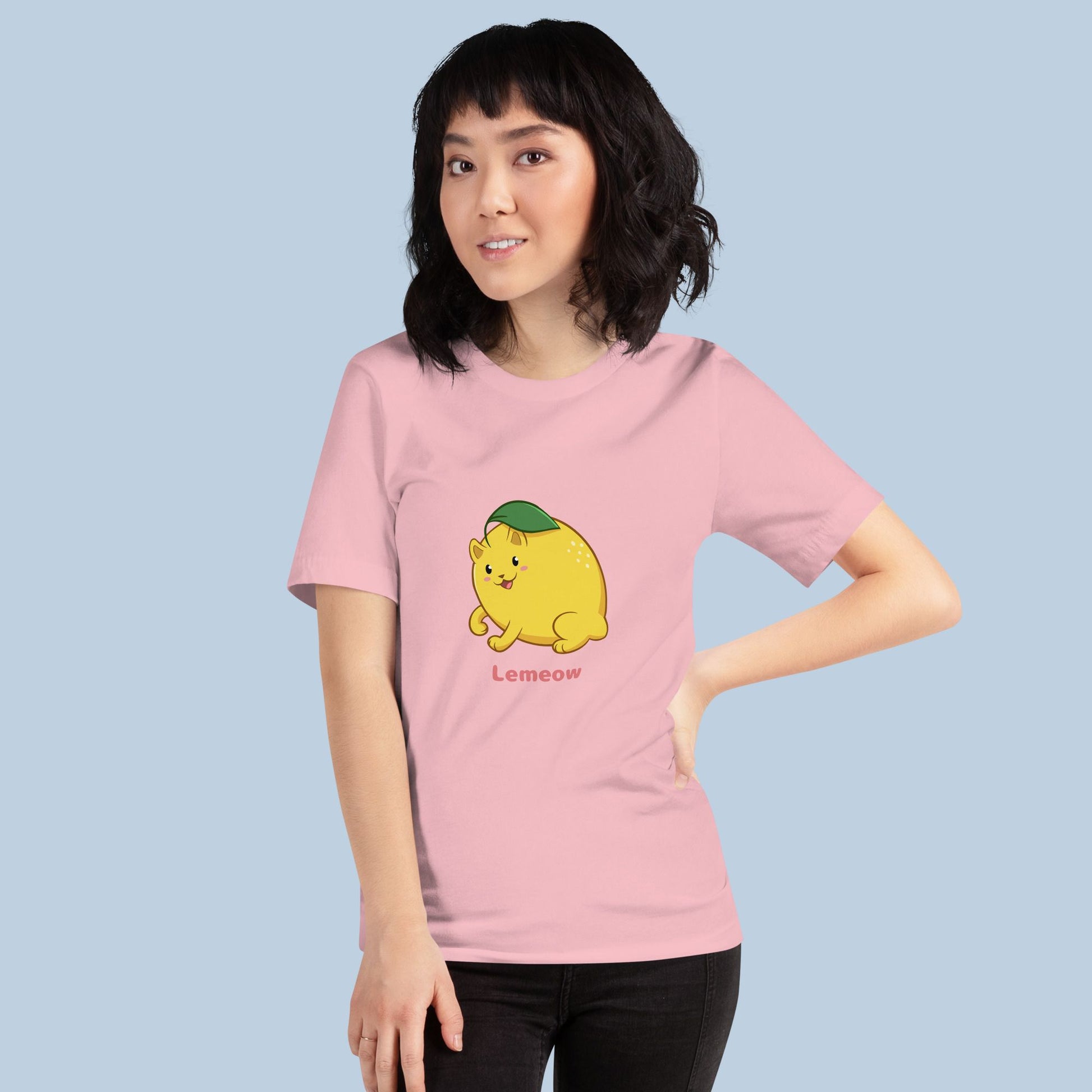 Woman wearing a pink T-Shirt with Lemeow™ print. Lemeow™ is a lemon drawn as a cute cat.