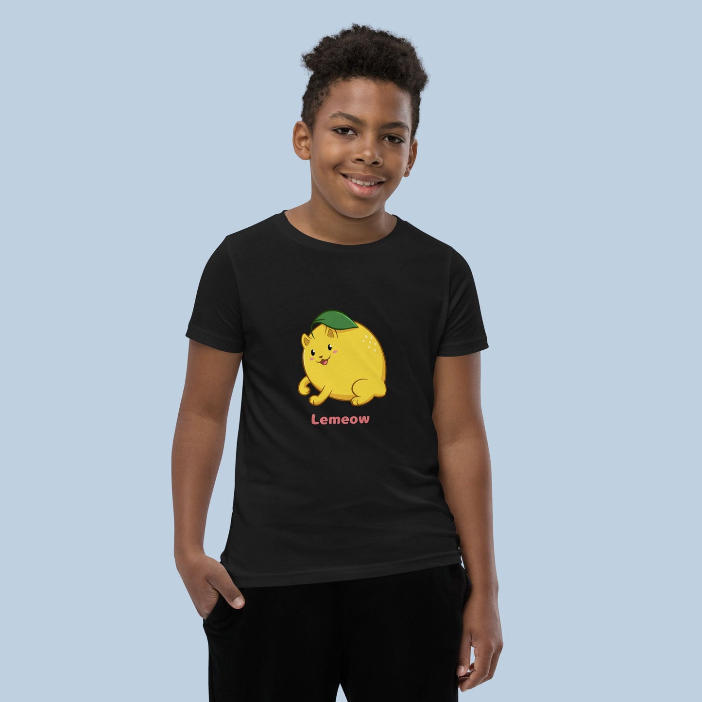 Boy wearing a black T-Shirt with Lemeow™ print. Lemeow™ is a lemon drawn as a cute cat.