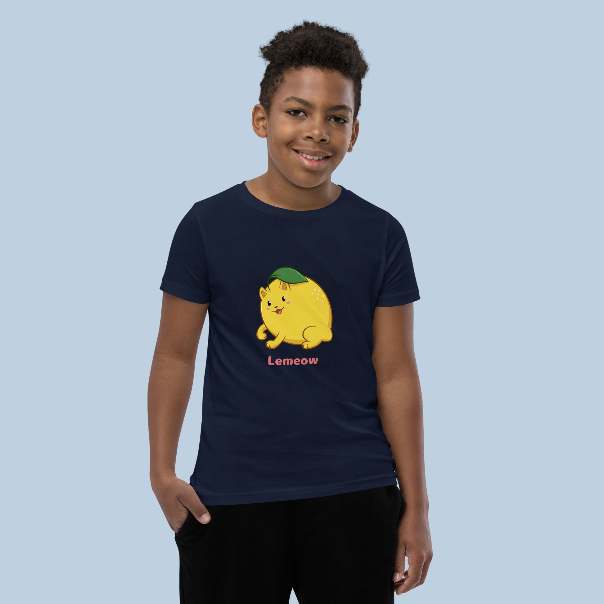 Boy wearing a navy blue T-Shirt with Lemeow™ print. Lemeow™ is a lemon drawn as a cute cat.