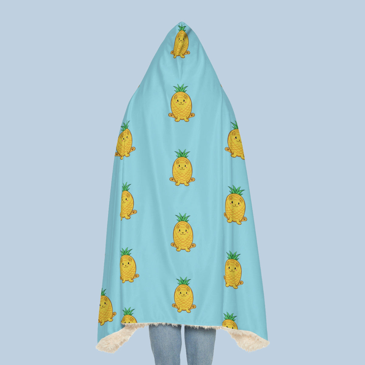 Happy woman wearing the light blue Pawnapple™ hooded sherpa blanket seen from behind. Pawnapple™ is a pineapple drawn as a cute cat.