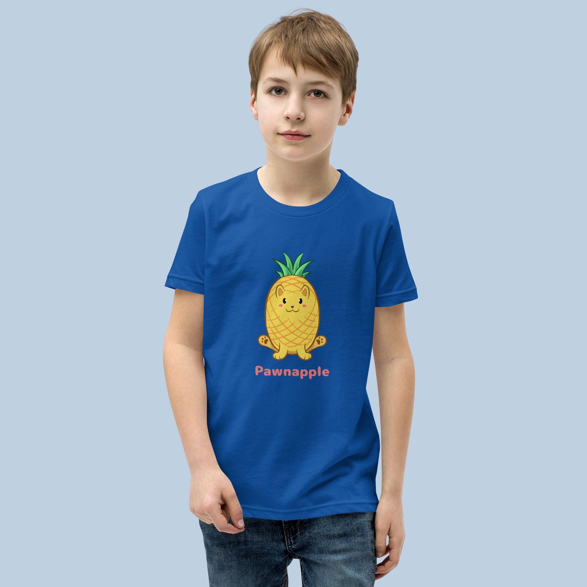 Boy wearing a royal blue T-Shirt with Pawnapple™ print. Pawnapple™ is a pineapple drawn as a cute cat.