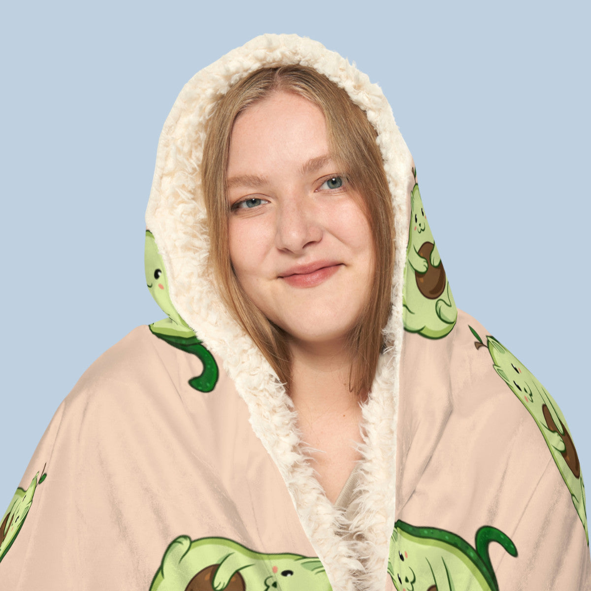 Happy woman wearing the beige Pawocado™ hooded sherpa blanket face zoomed in. Pawocado™ is an avocado drawn as a cute cat.