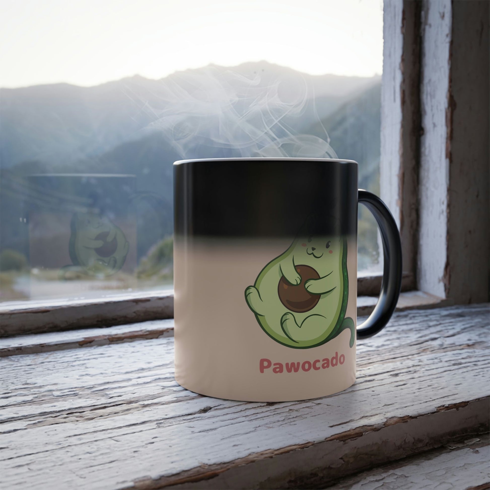 Beige Magic Mug with Pawocado™ print standing in a window turning from black into the print. Pawocado™ is an avocado drawn as a cute cat.