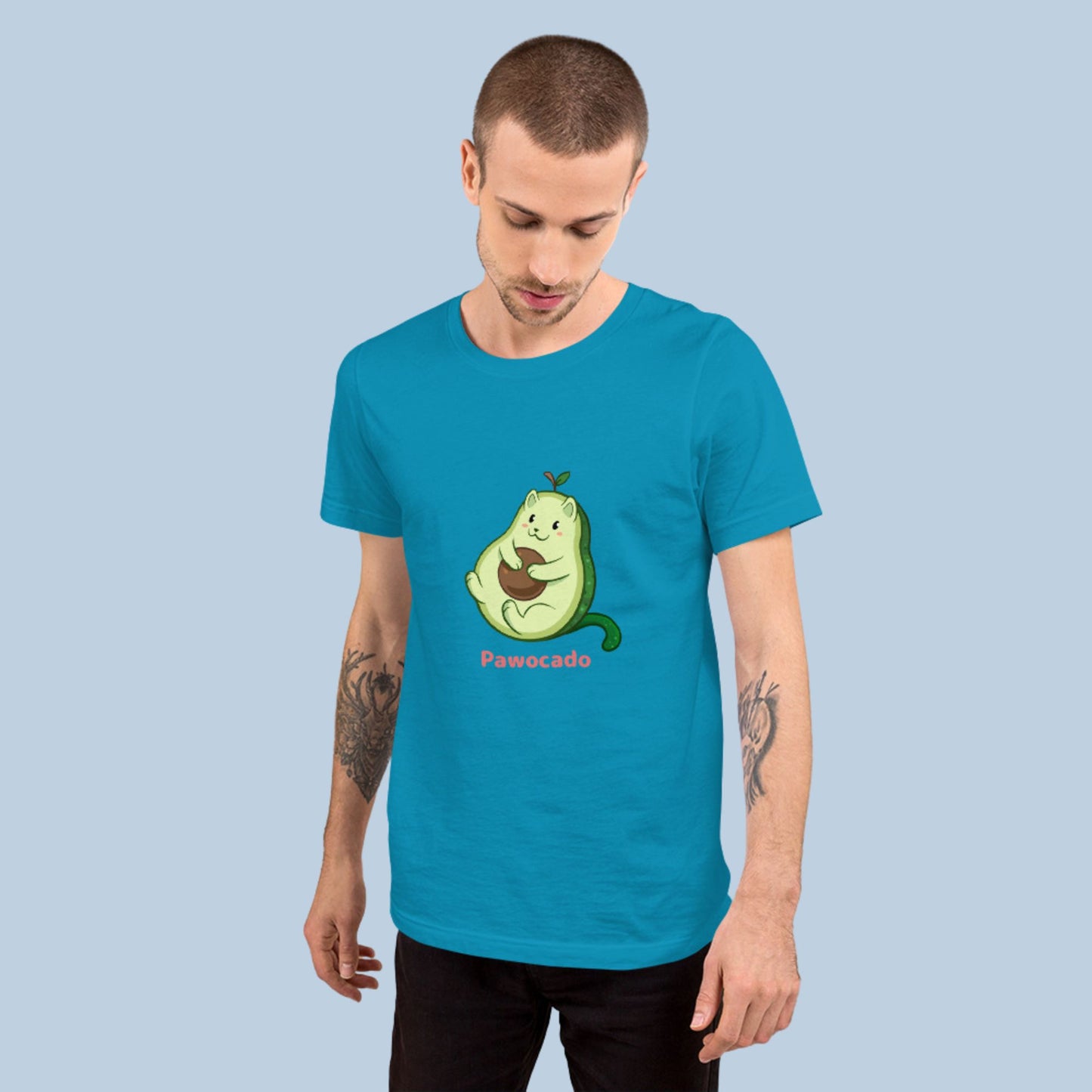 Man wearing an aqua blue T-Shirt with Pawocado™ print. Pawocado™ is an avocado drawn as a cute cat.