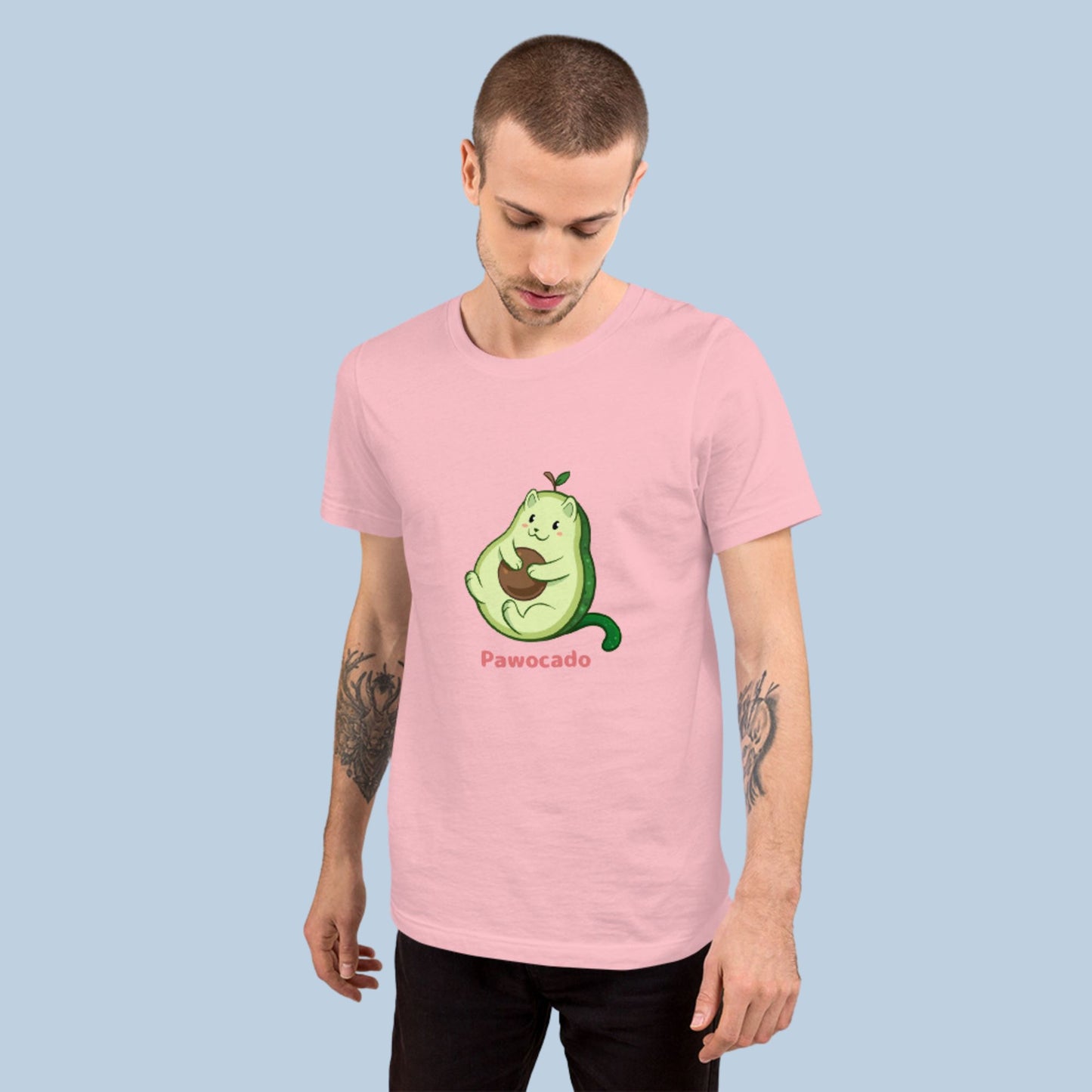 Man wearing a pink T-Shirt with Pawocado™ print. Pawocado™ is an avocado drawn as a cute cat.