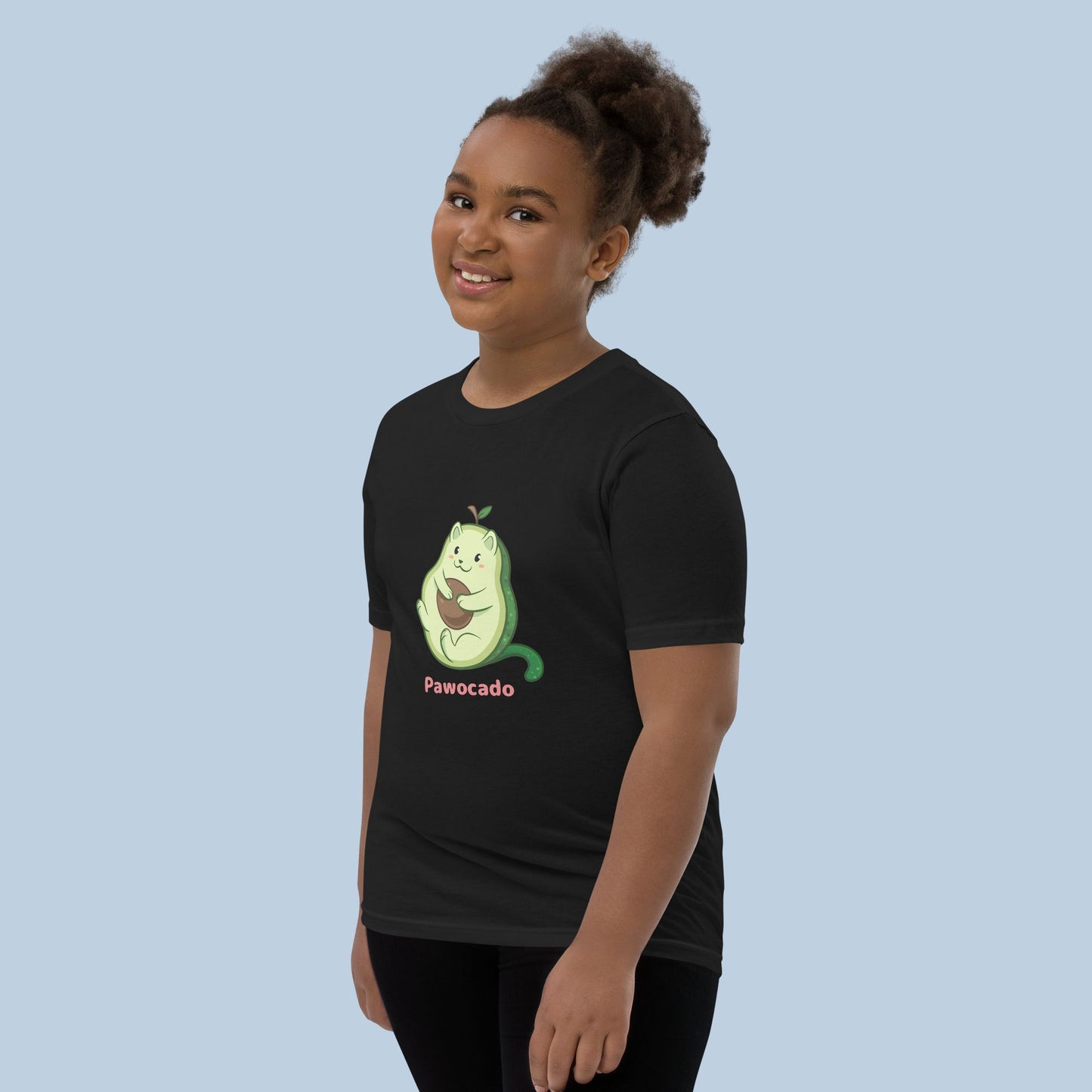 Girl wearing a black T-Shirt with Pawocado™ print. Pawocado™ is an avocado drawn as a cute cat.