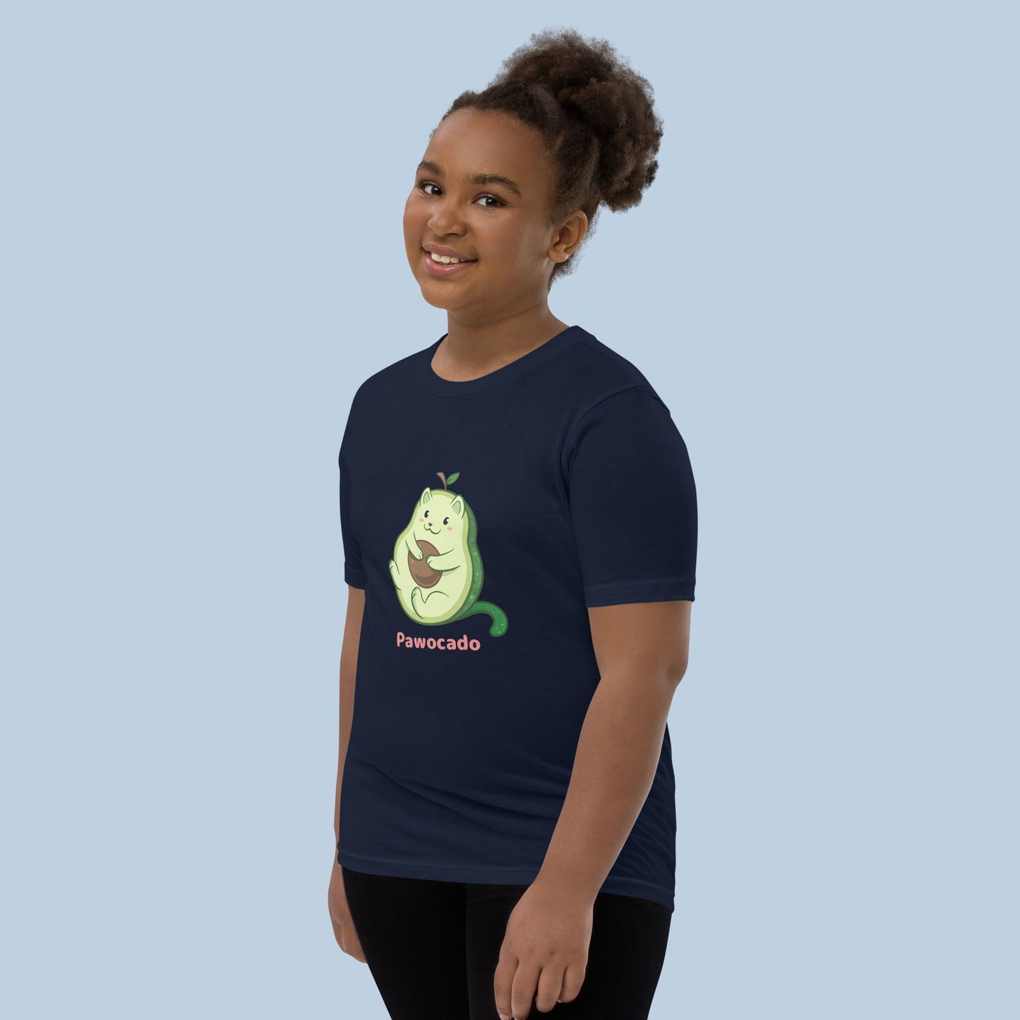 Girl wearing a navy blue T-Shirt with Pawocado™ print. Pawocado™ is an avocado drawn as a cute cat.