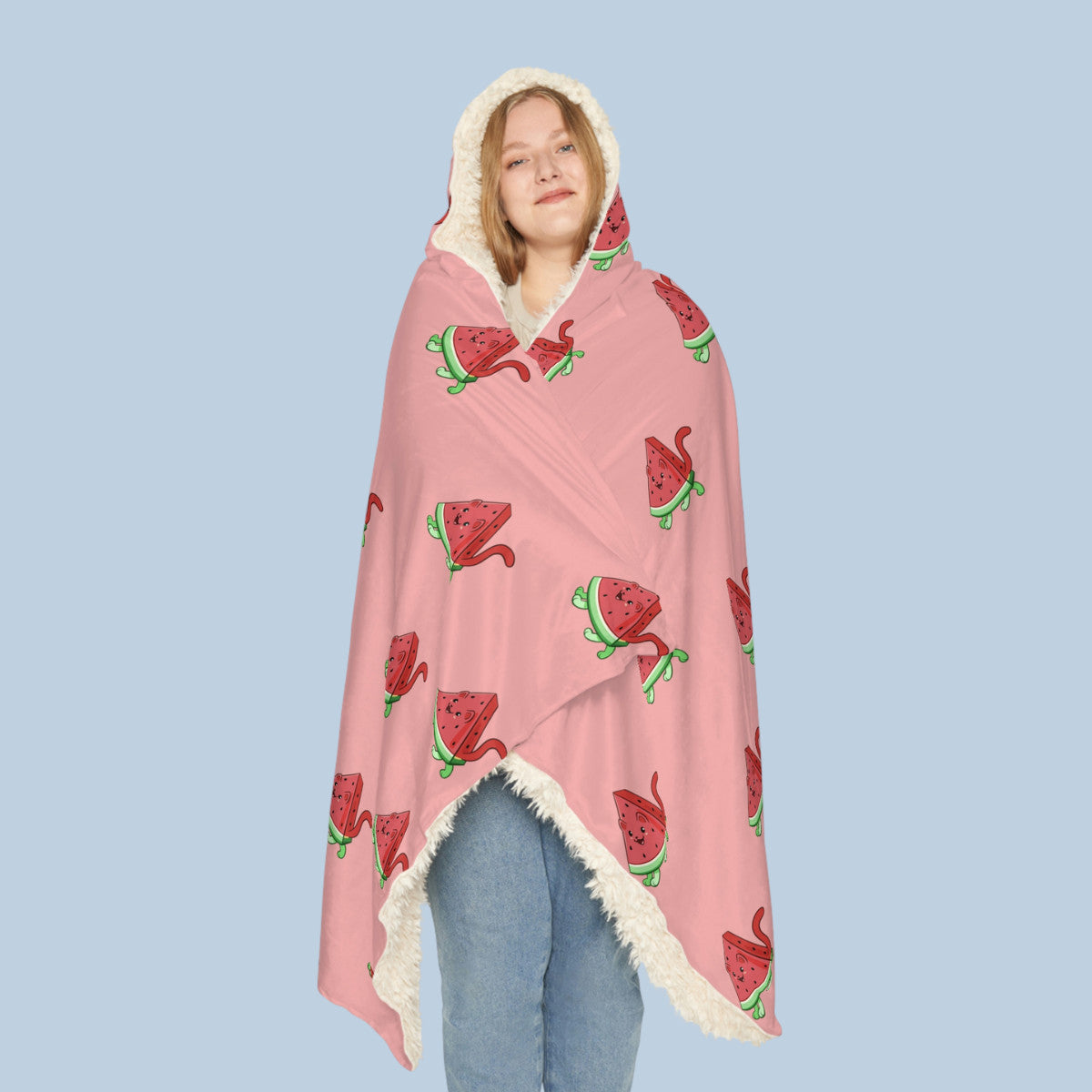 Happy woman wearing the pink Watermewlon™ hooded sherpa blanket seen from front. Watermewlon™ is a watermelon drawn as a cute cat.