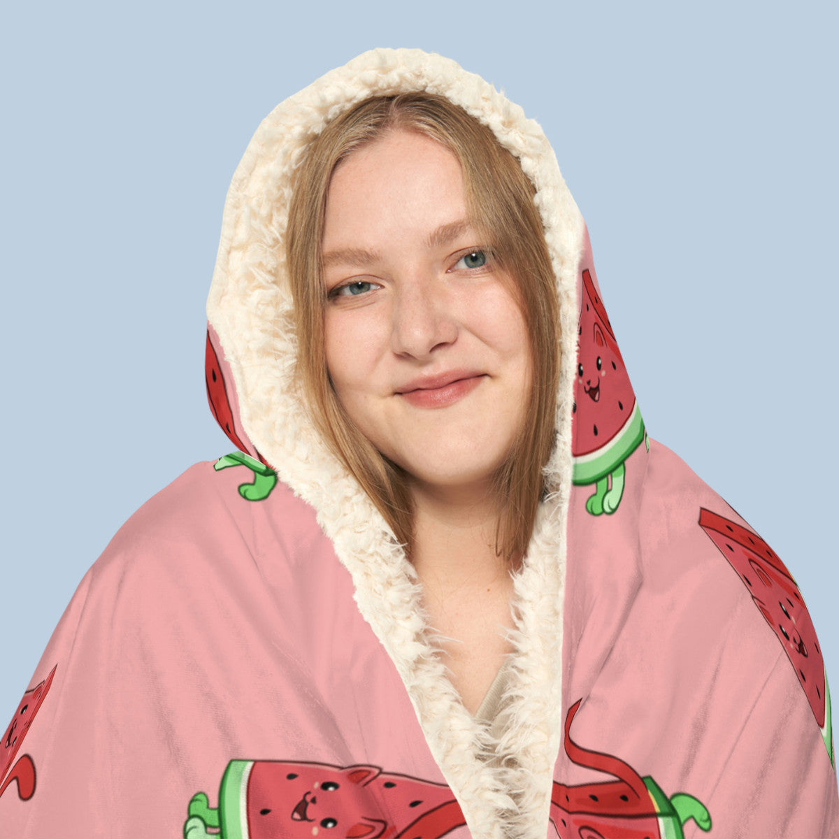 Happy woman wearing the pink Watermewlon™ hooded sherpa blanket face zoomed in. Watermewlon™ is a watermelon drawn as a cute cat.