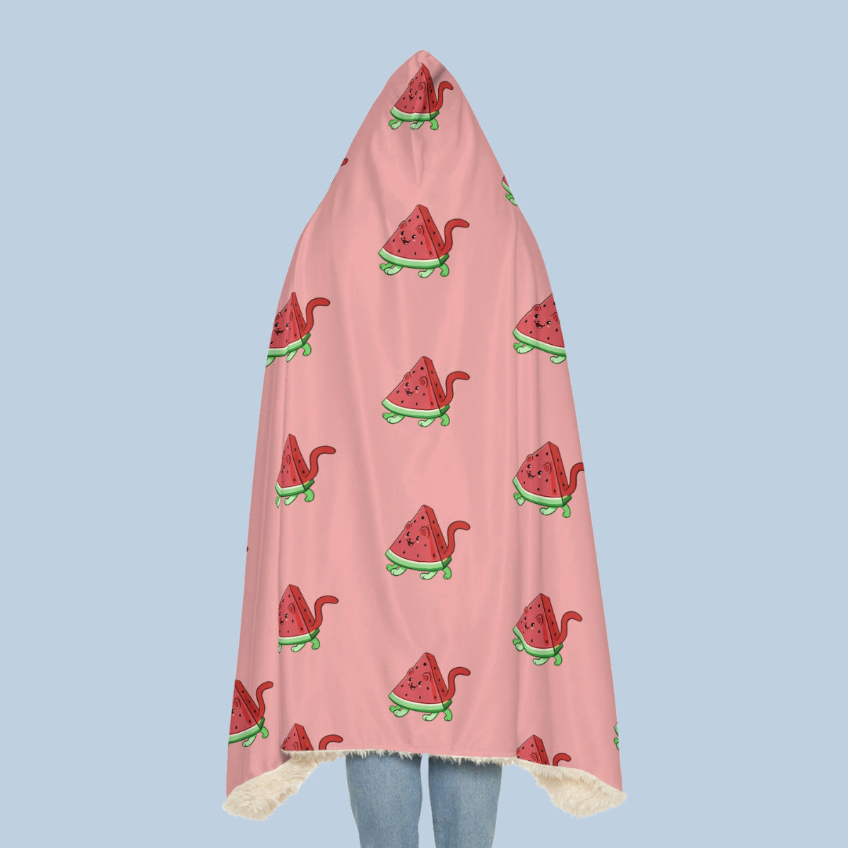 Happy woman wearing the pink Watermewlon™ hooded sherpa blanket seen from behind. Watermewlon™ is a watermelon drawn as a cute cat.