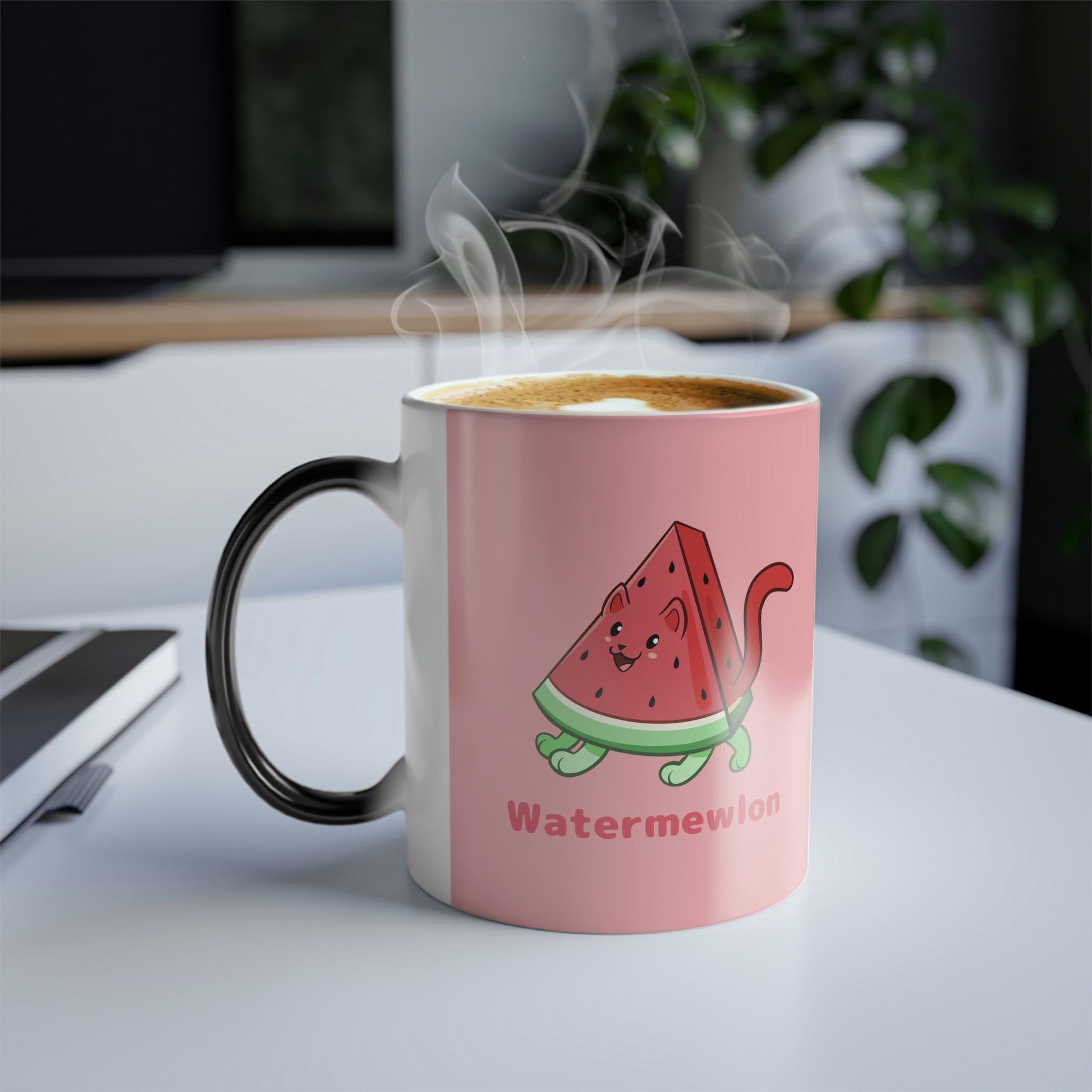 Pink Magic Mug with Watermewlon™ print standing on an office desk. Watermewlon™ is a watermelon drawn as a cute cat.