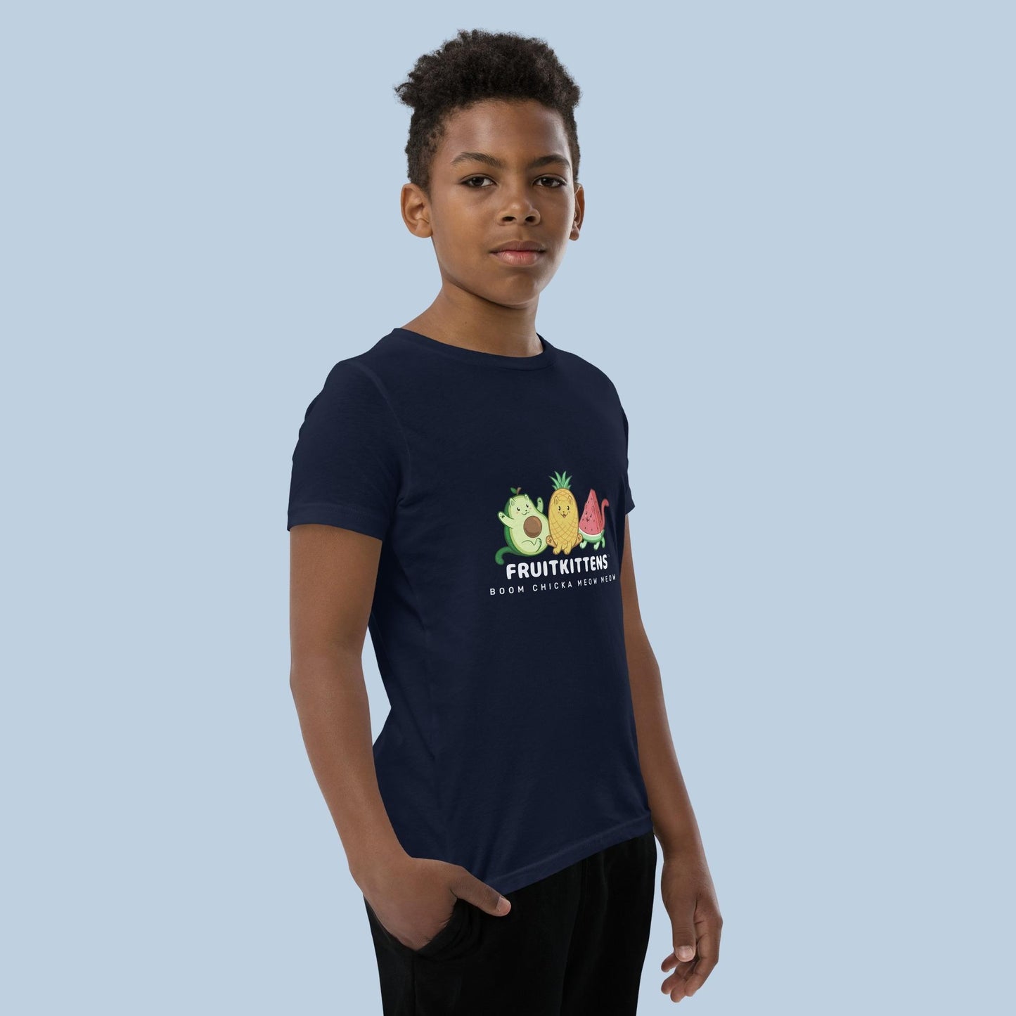 Boy wearing a navy blue T-Shirt with Fruitkittens™ logo. Fruitkittens™ are fruits drawn as cute cats. The logo features Pawocado™, Pawnapple™ and Watermewlon™.